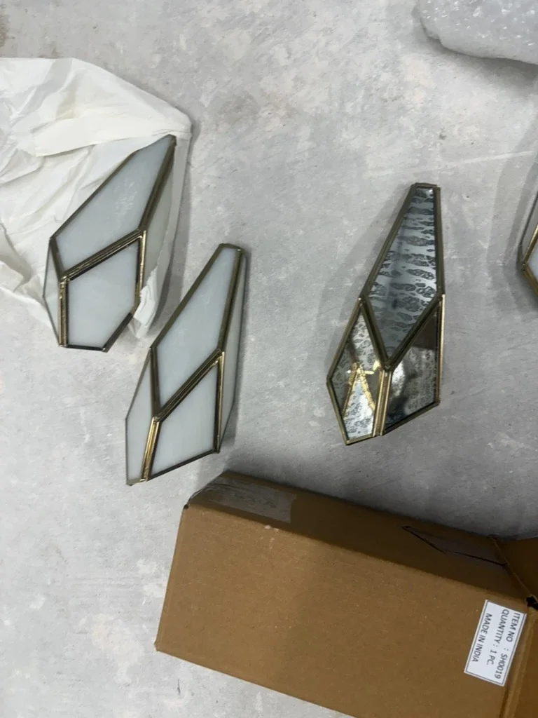 Brass and glass faceted wall sconces for The Platform in Frisco, TX, unboxed on site. Designed by Artbuckle & Co.