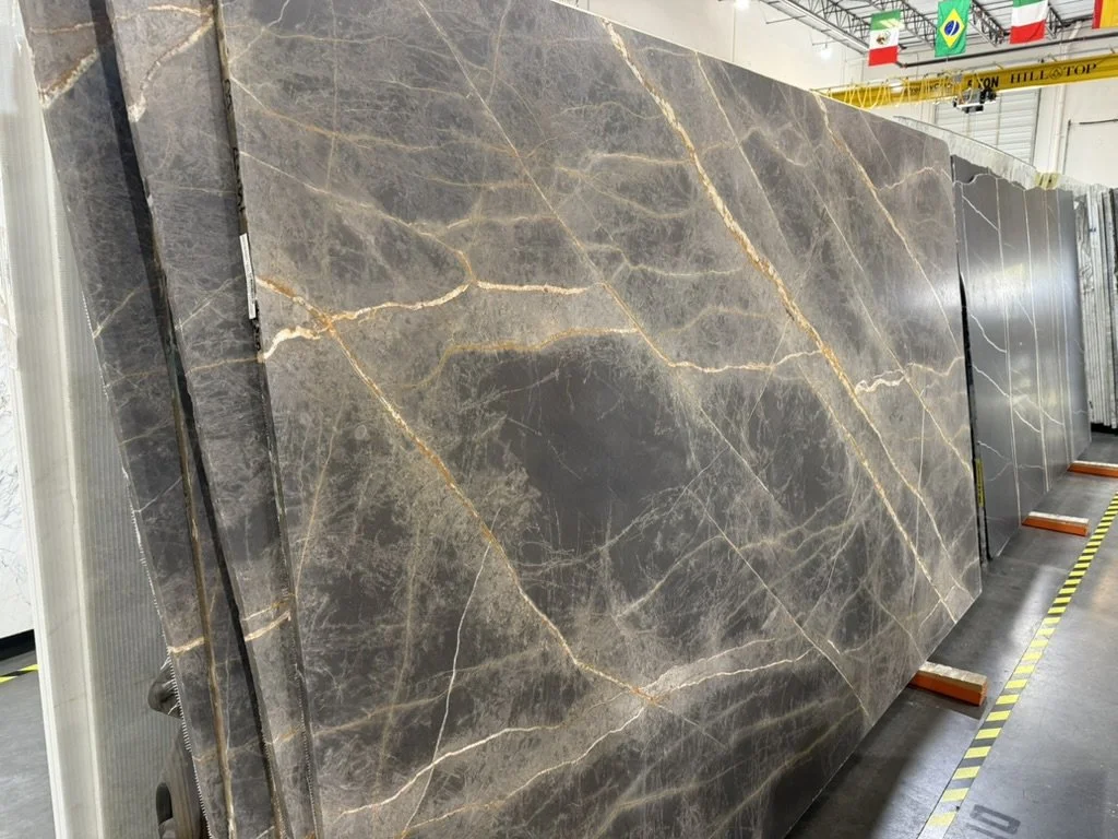 Trade-only stone slab with gold veining selected for the custom reception counter at Beacon at the Rail District in Frisco, TX, curated by Artbuckle & Co.