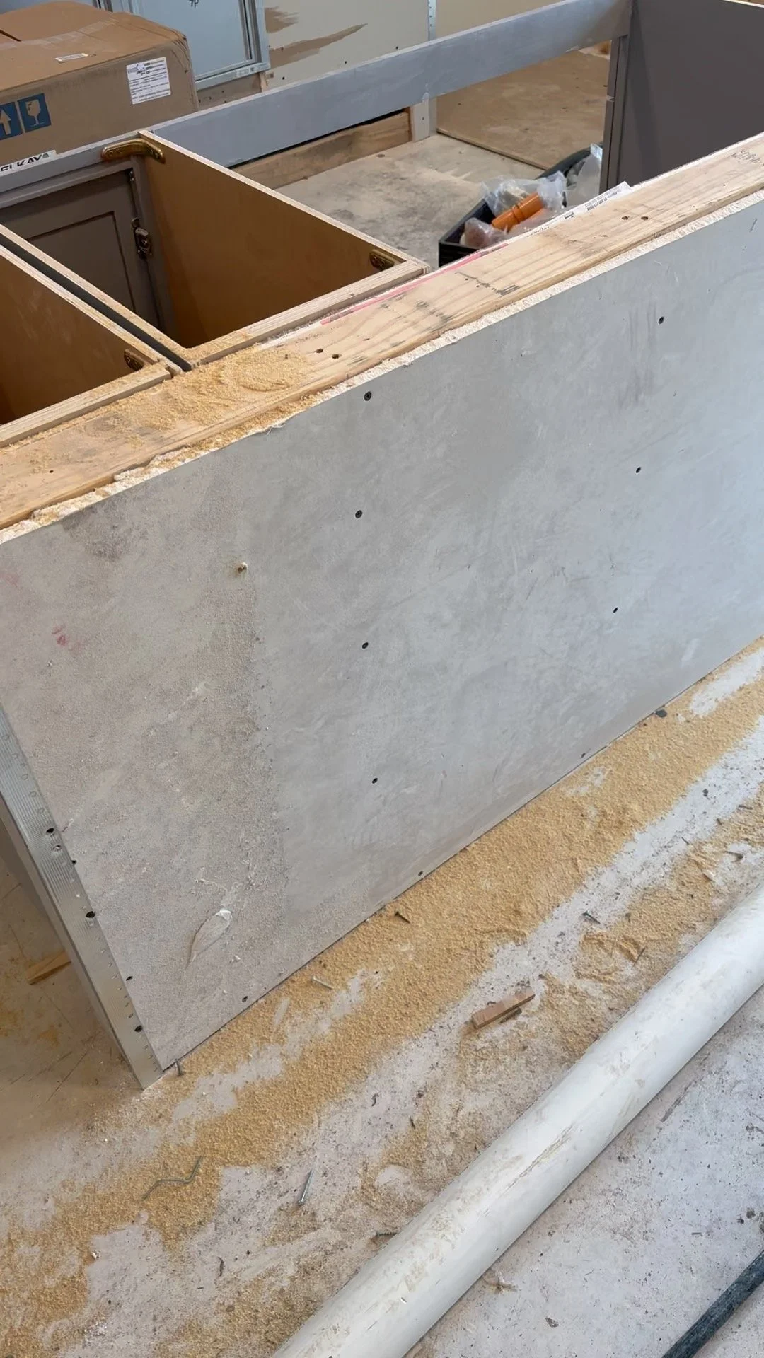 Raw framing and concrete subfloor during the amenity bar buildout at East 9th apartments in Dallas, TX, managed by Artbuckle & Co.