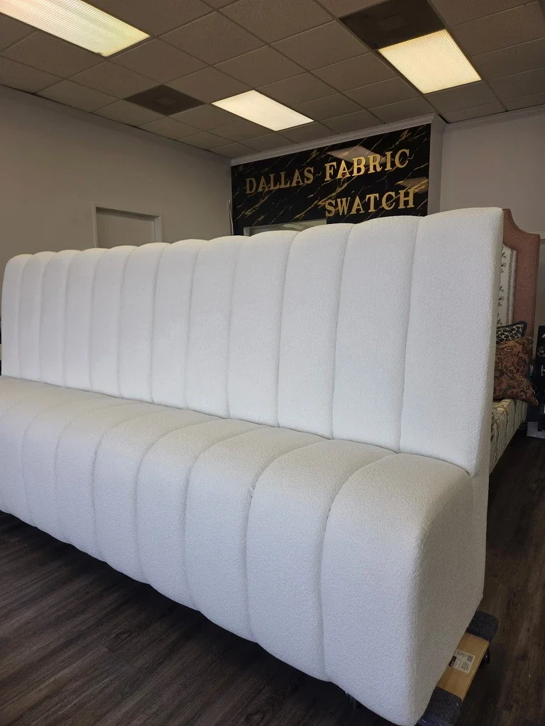 Custom cream channel-tufted bouclé banquette for The Platform in Frisco, TX at the upholstery workshop. Designed by Artbuckle & Co. Built by Dallas Fabric Swatch.