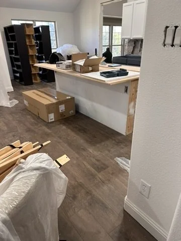 Wood-look floor tile installation and island drywall prep during a residential kitchen overhaul in Sunnyvale, TX, by Artbuckle & Co.