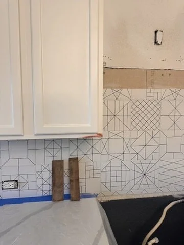 In-progress installation of white geometric tile backsplash and custom white upper cabinets in a Sunnyvale, TX kitchen, by Artbuckle & Co.