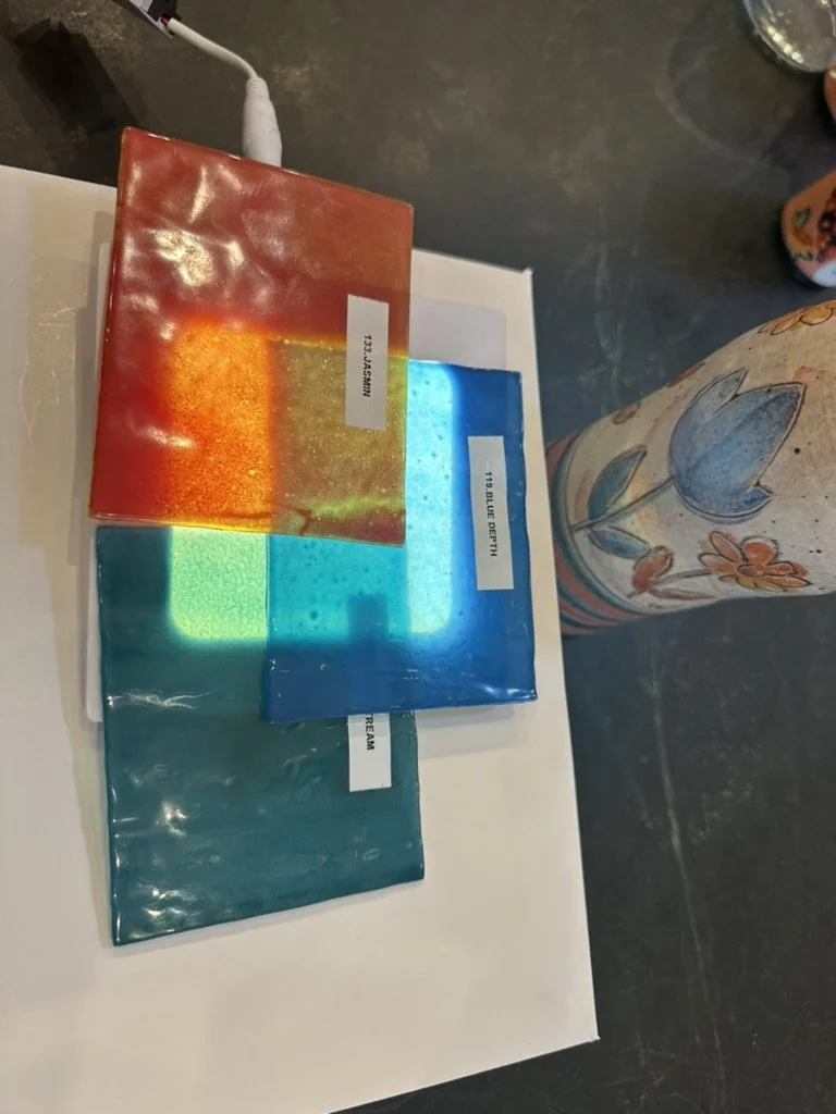 Translucent glass color samples in orange, blue, and teal, reviewed for the custom pendant lighting in a Lakewood Hills home in Dallas, Texas, by Artbuckle & Co.