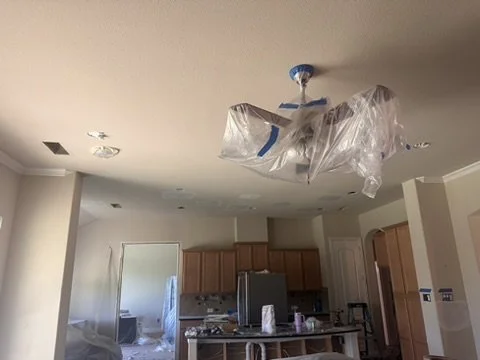 Living room ceiling prep and lighting fixture protection during an interior residential renovation in Sunnyvale, TX, by Artbuckle & Co.