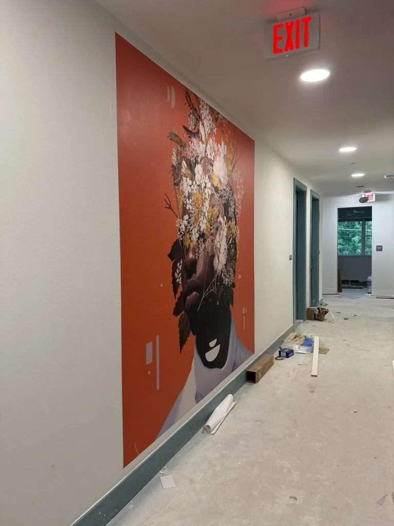 In-progress installation of a vibrant red Frank Moth floral mural along an apartment hallway at East 9th in Dallas, TX, by Artbuckle & Co.