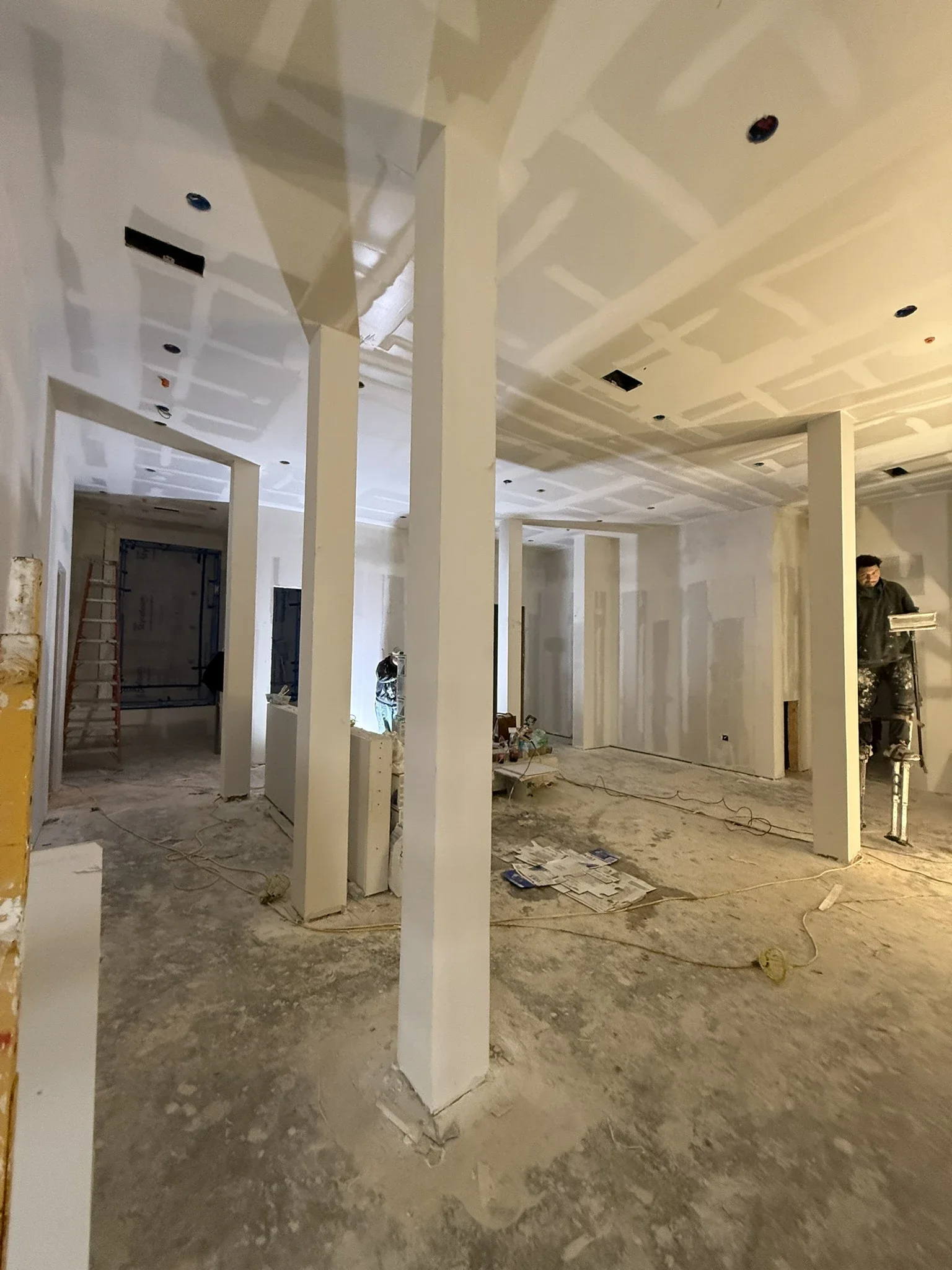 Lobby under construction at The Platform in Frisco, TX with framed openings and white columns. Designed by Artbuckle & Co