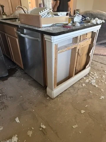 In-progress kitchen island demolition and cabinet framing during a residential remodel in Sunnyvale, TX, managed by Artbuckle & Co.