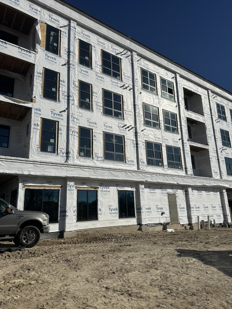 Exterior building envelope and window framing during early construction at Beacon at the Rail District in Frisco, TX, interior designed by Artbuckle & Co.