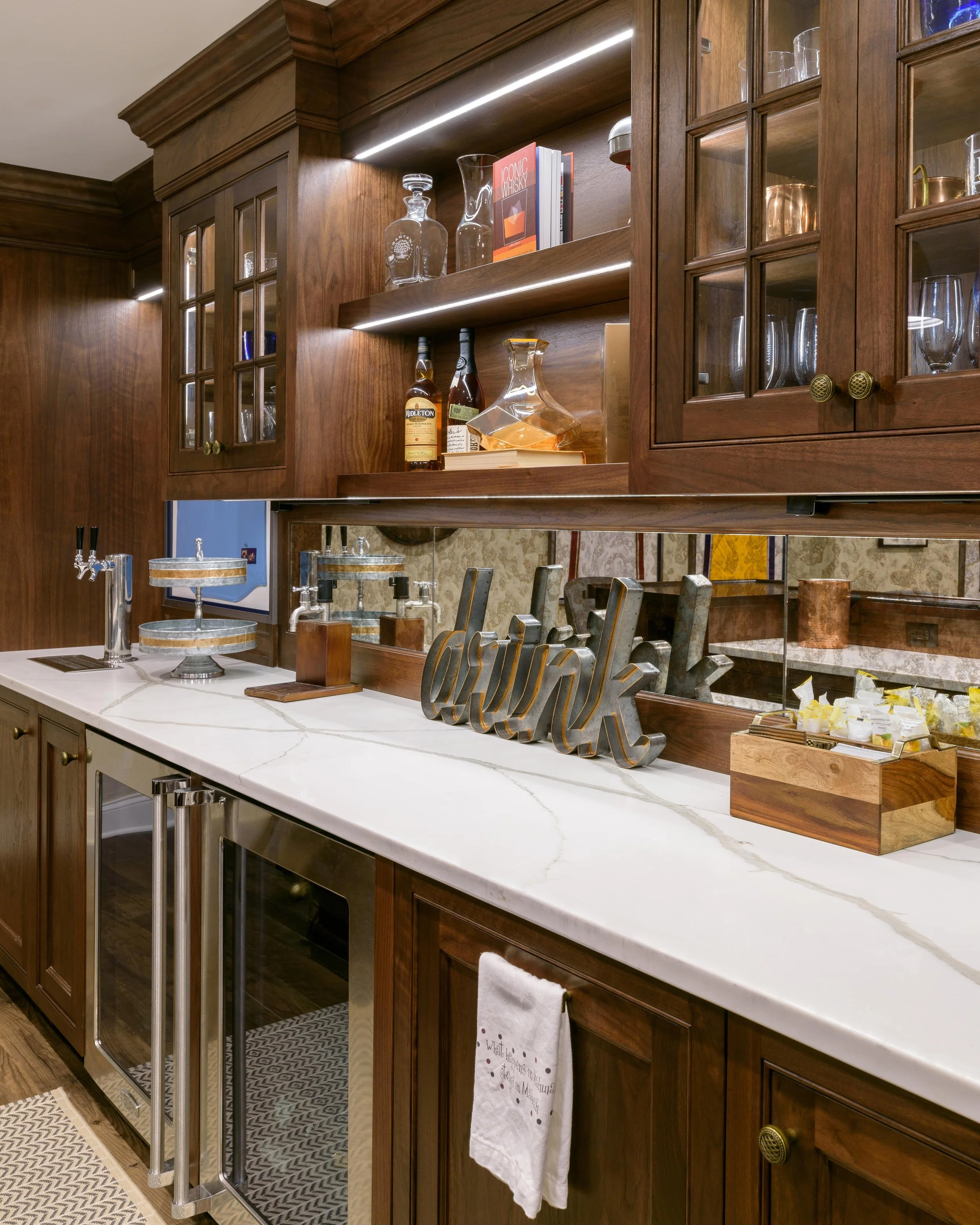 Stylish basement design blending a sports-bar feel with family comfort in the Game on at Heritage project.