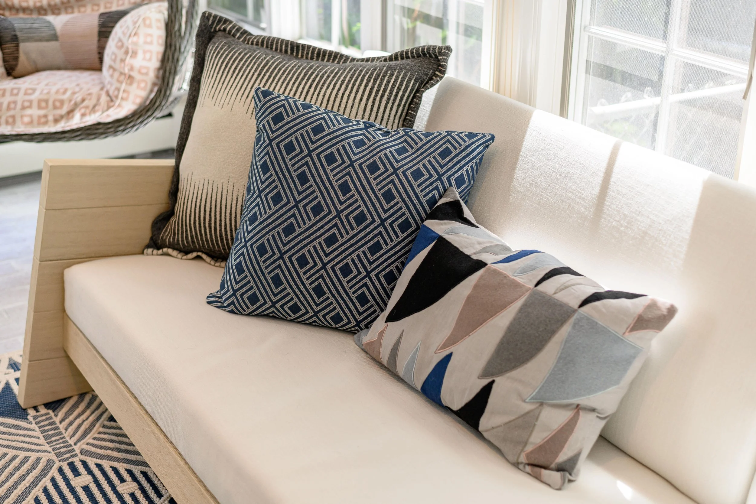 Indoor-outdoor sunroom and vibrant family spaces in the Moments on Madison project by Melissa’s Designs.