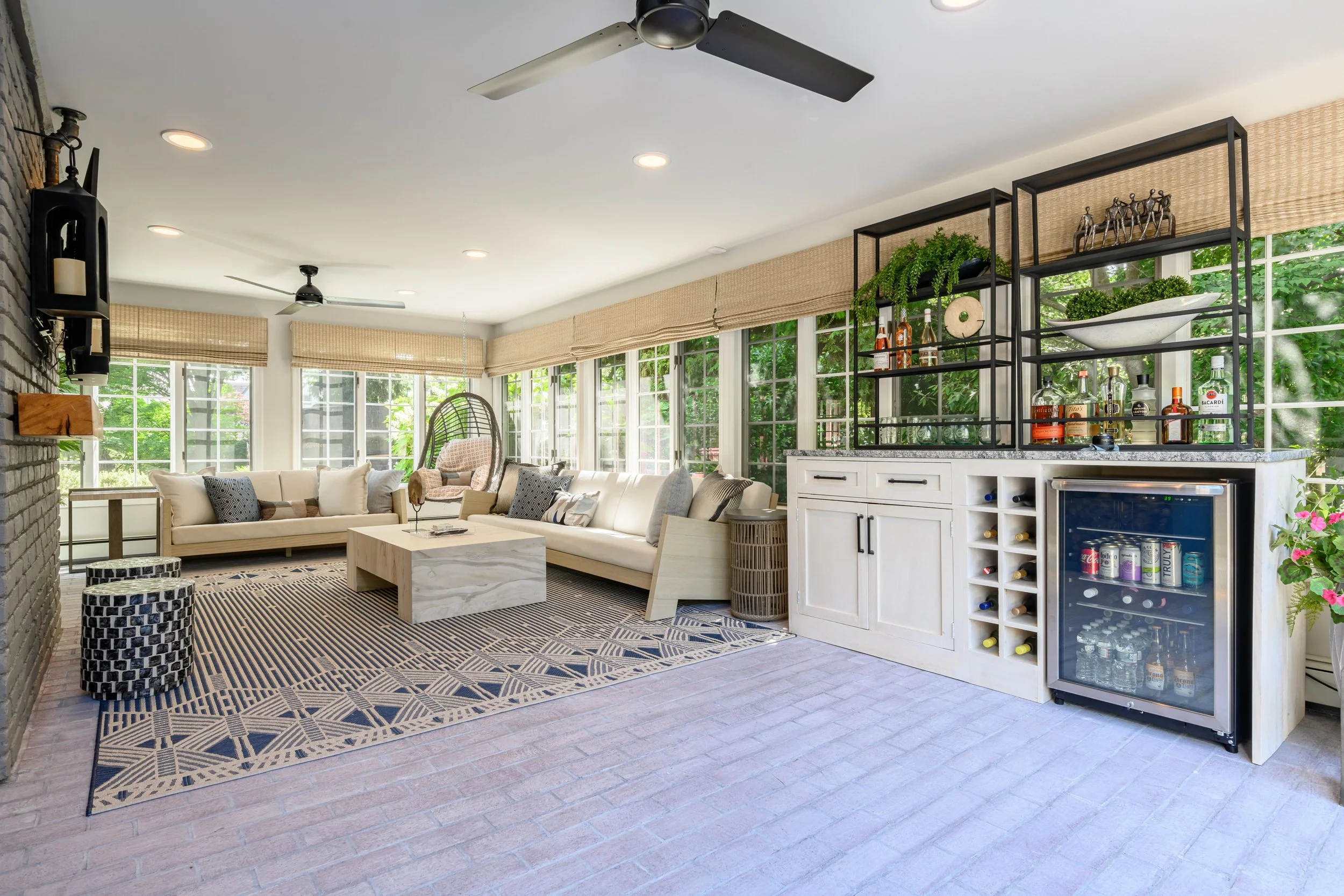 Indoor-outdoor sunroom and vibrant family spaces in the Moments on Madison project by Melissa’s Designs.