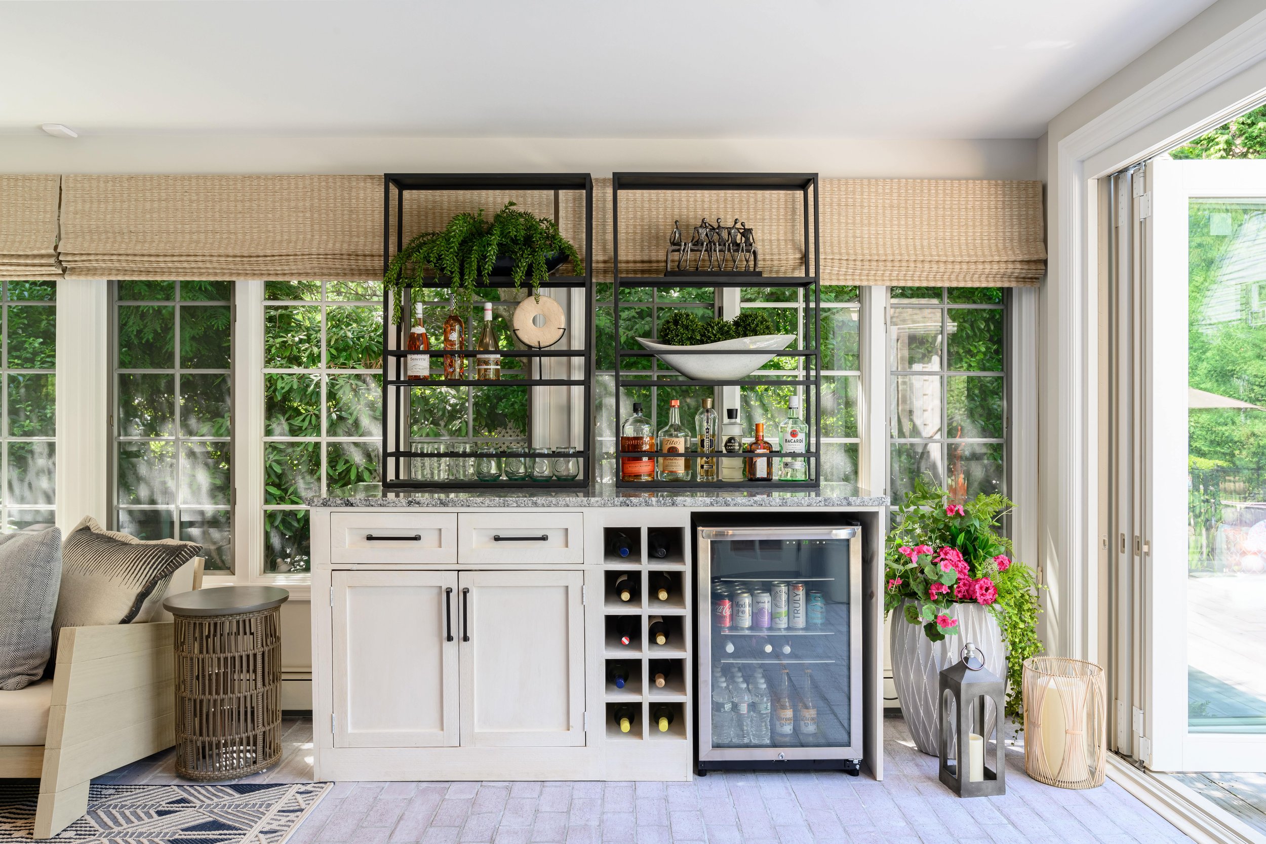 Indoor-outdoor sunroom and vibrant family spaces in the Moments on Madison project by Melissa’s Designs.