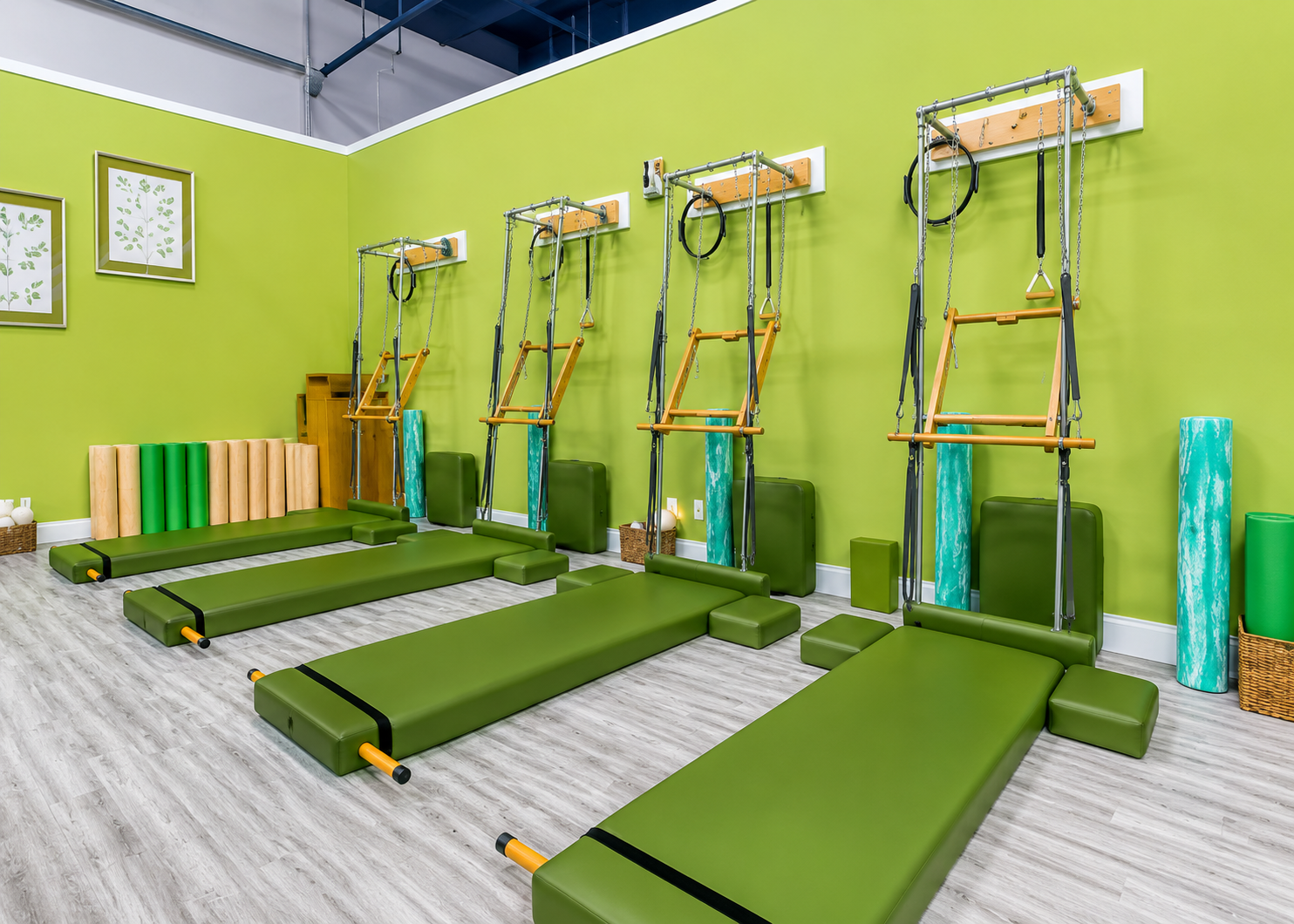 Indoor Pilates room with green mats.