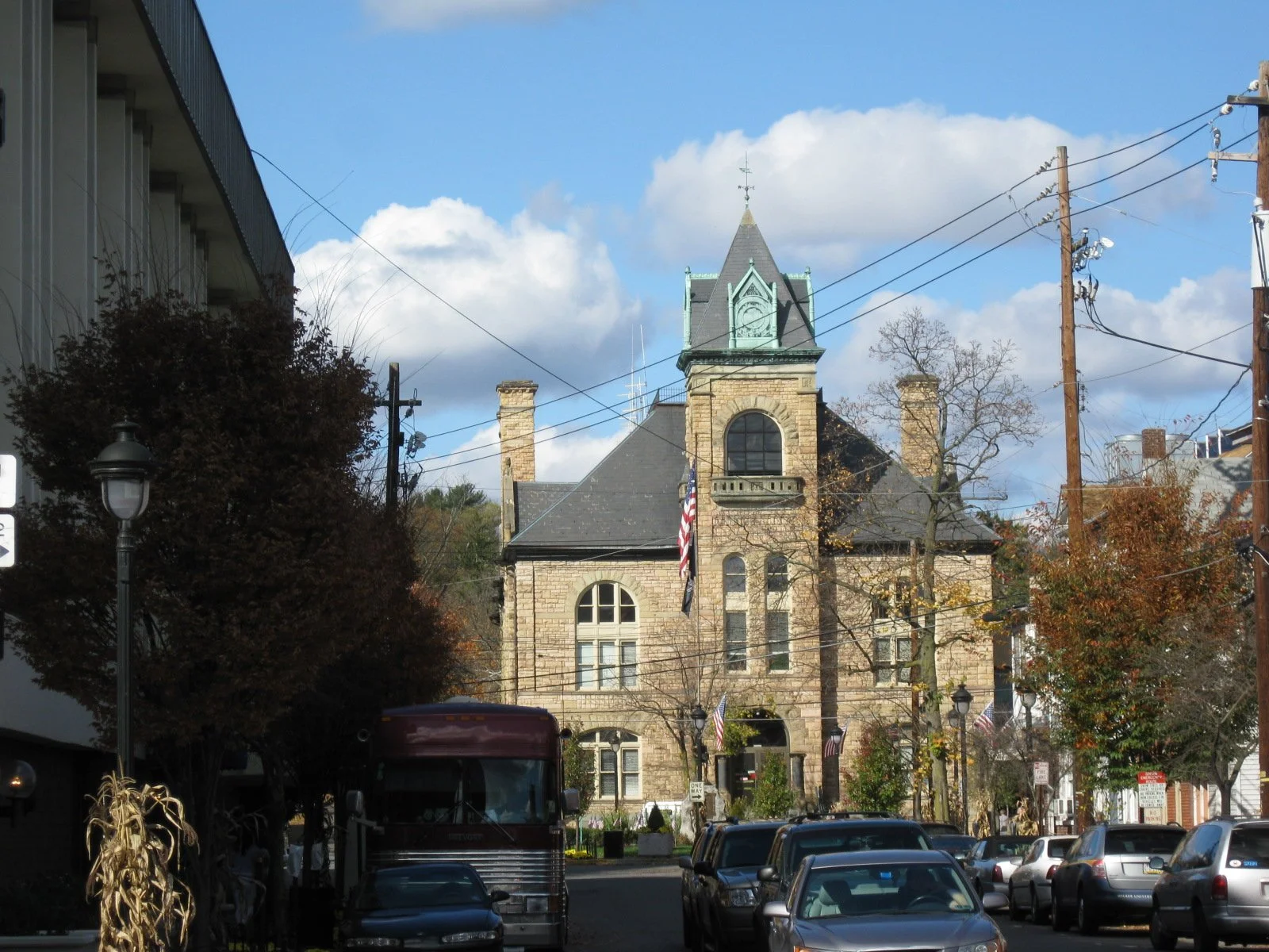 The historic stone Monroe County Courthouse with its clock tower on a street in downtown Stroudsburg, Pennsylvania