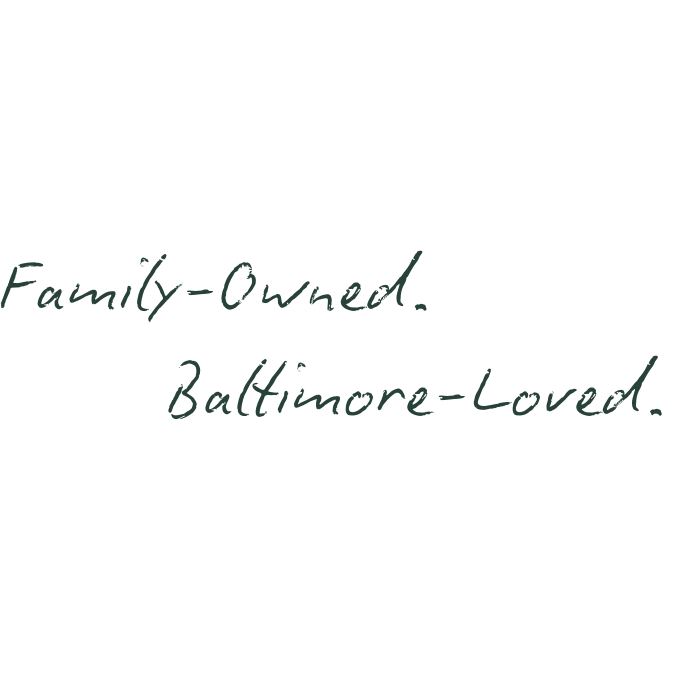 A handwritten note on a black background that says, 'Family-Owned. Baltimore-Loved.' in cursive writing.
