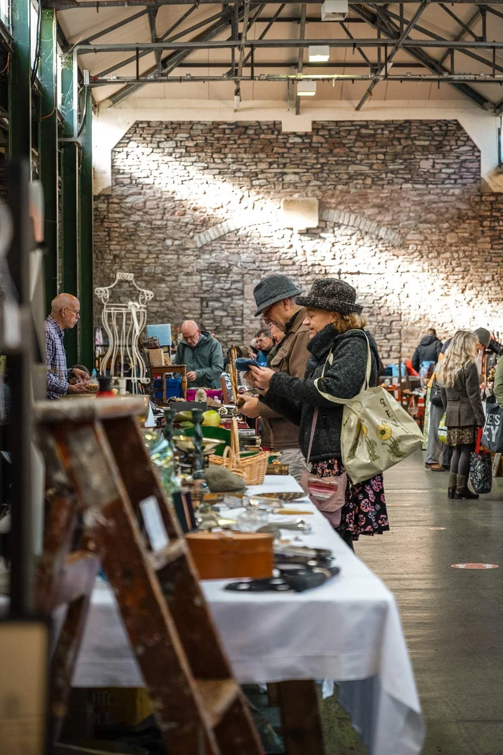 Visitors to the Saturday Market in Brecon Market Hall in Powys.