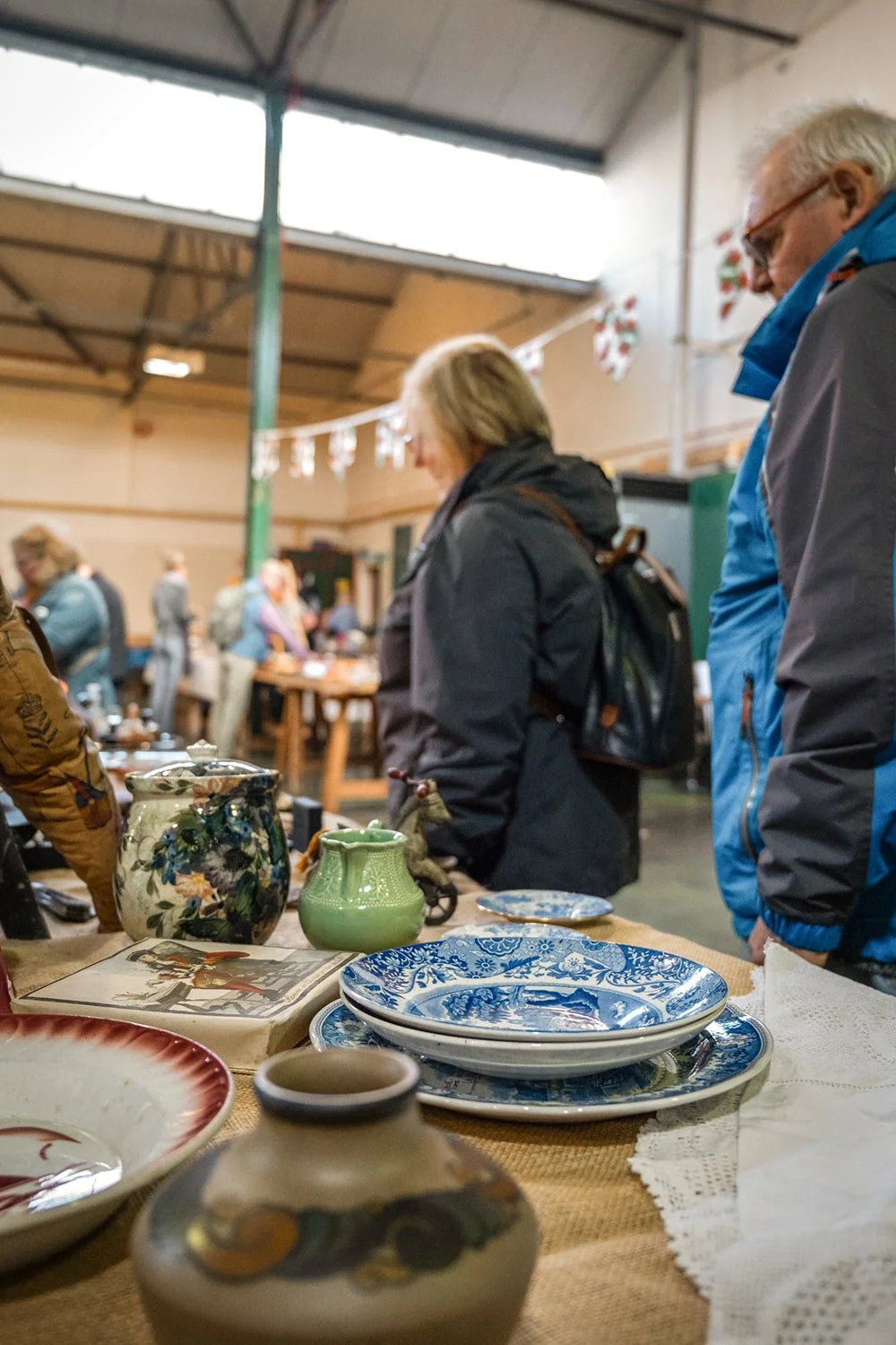 Customers browsing the stalls at the Saturday Market in Brecon Market Hall in Powys.