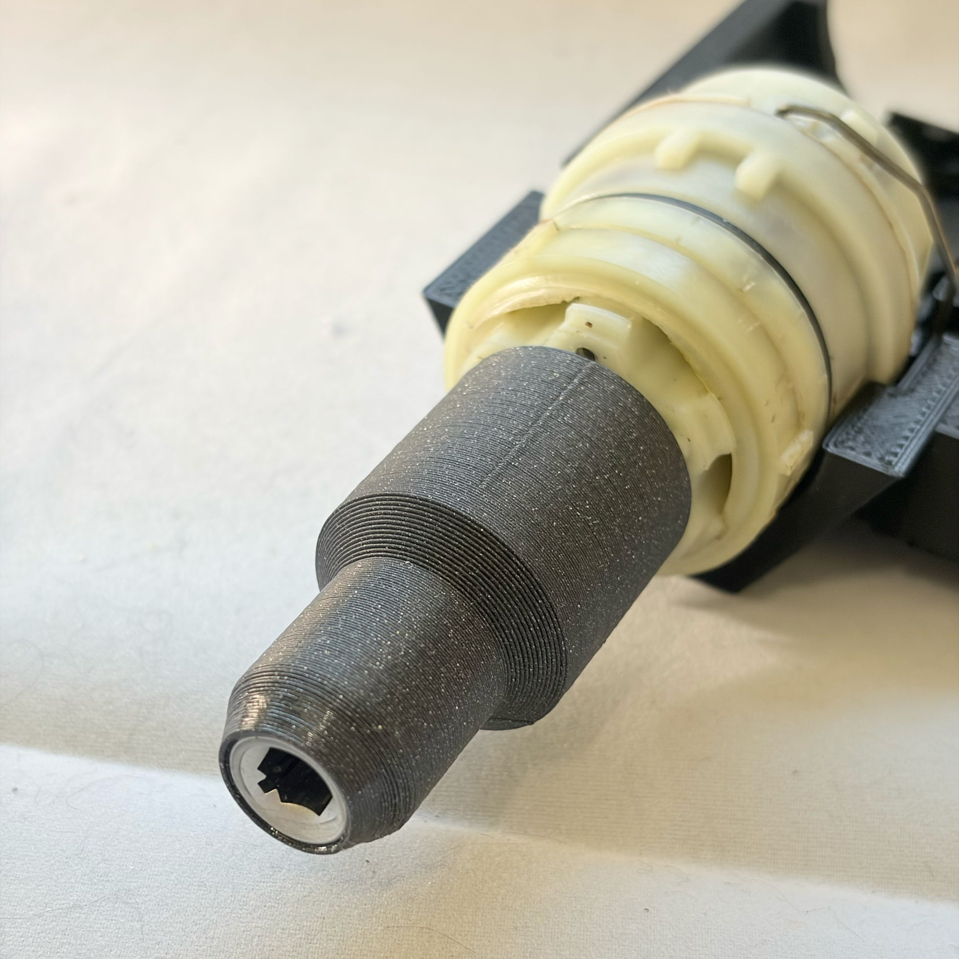 Adapter for  connecting the motor's d-shaft to the grinder's hex-shaft.