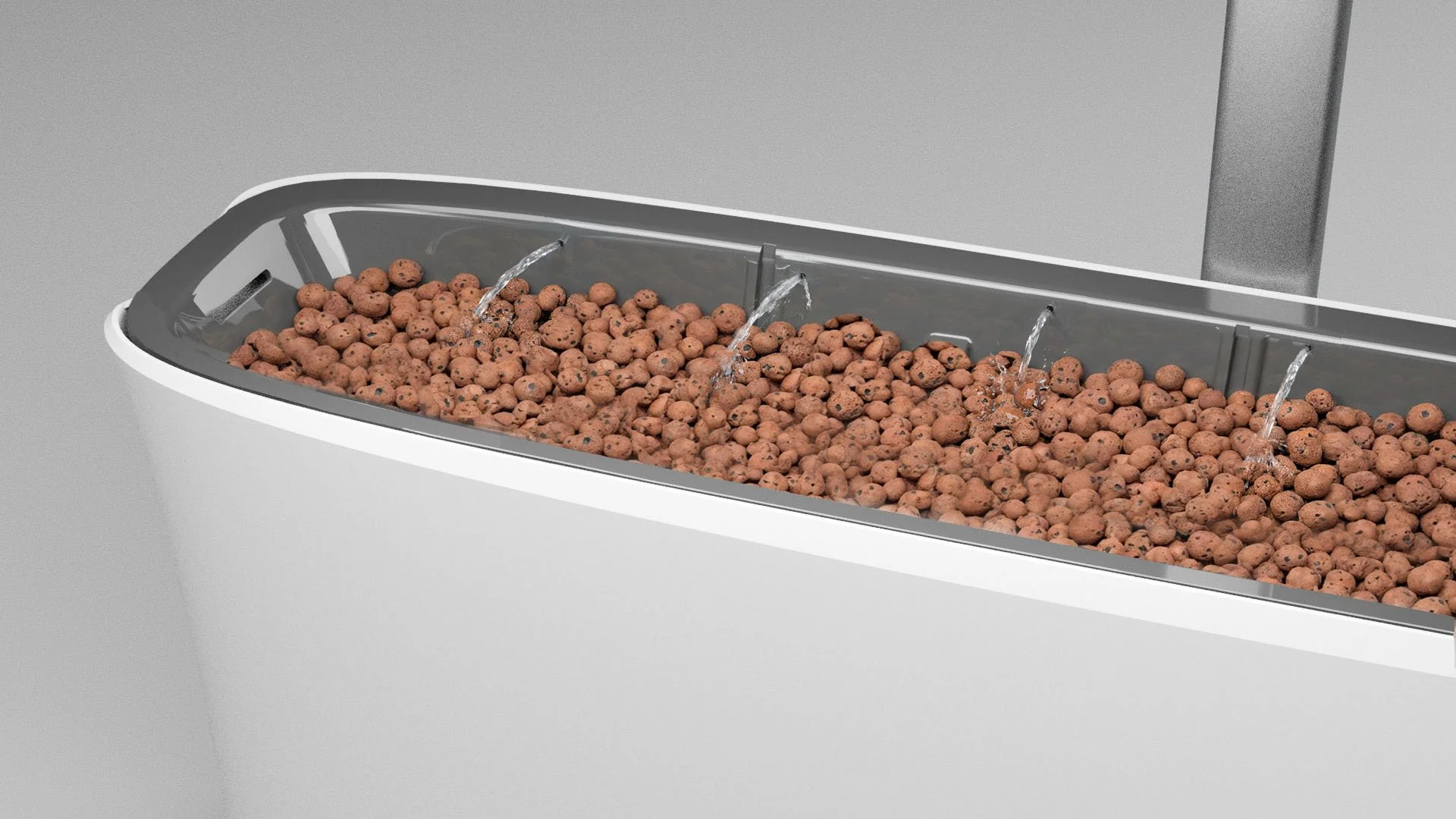 Instead of soil, the plants grow in balls of burnt clay  (LECA). Regardless of the plants, this allows for a root environment that allows for regular watering every third hour. This kind of growing is called hydroponic growing, 