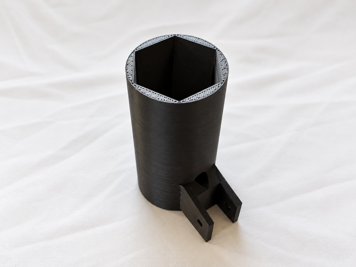 A part that holds the motor and is meant to be attached to an aluminum extrusion