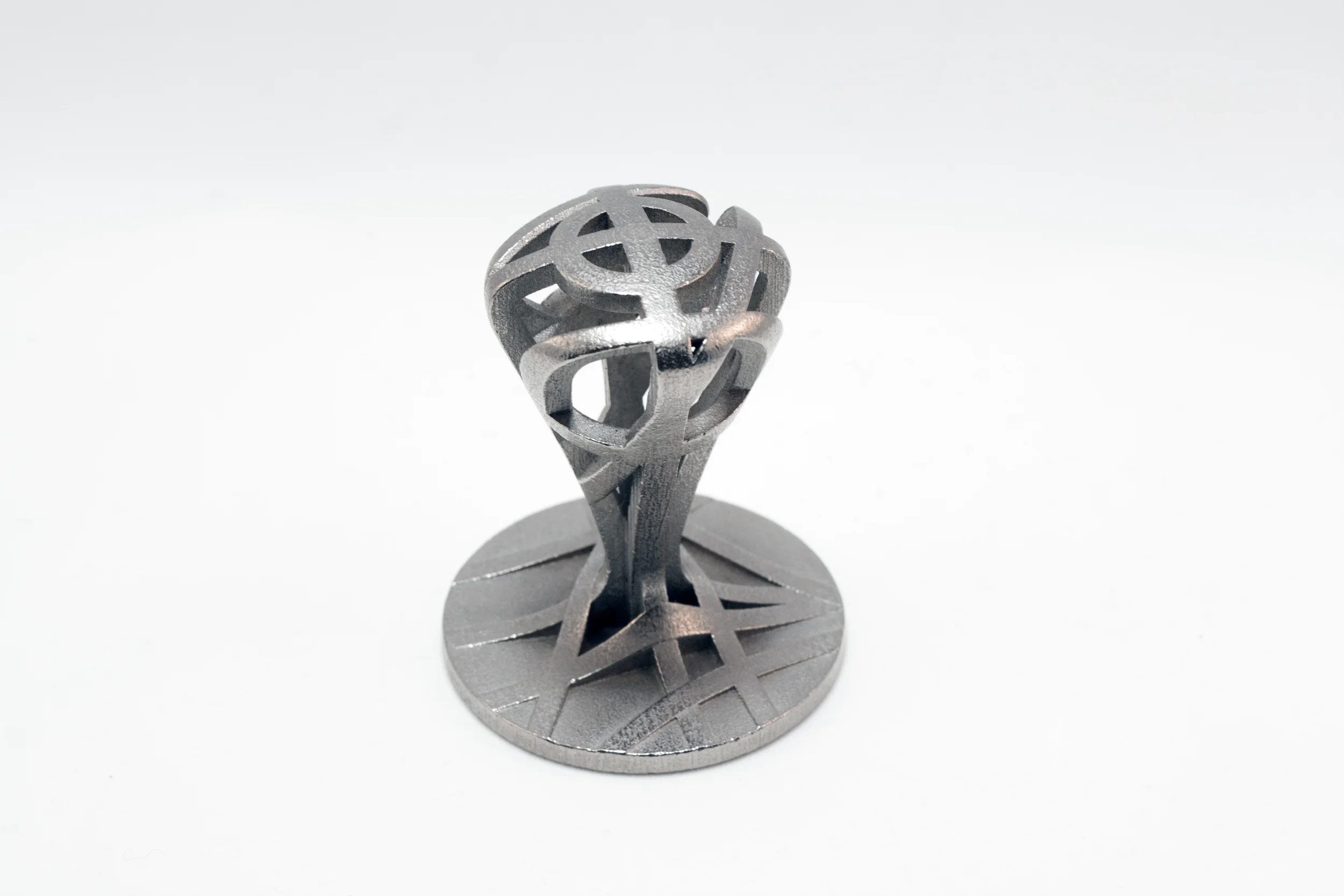An espresso tamper made of 3D printed stainless steel.