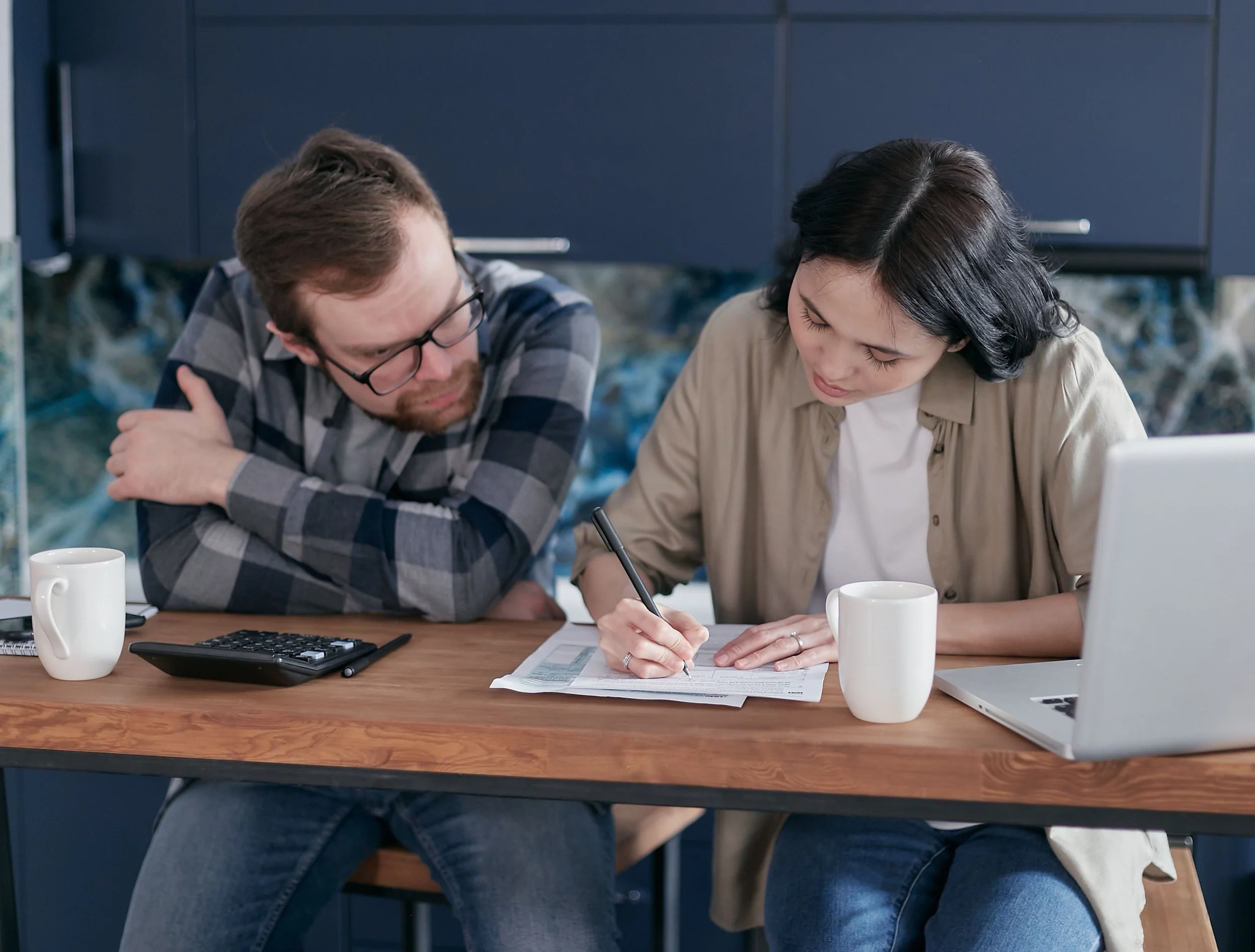 Couple reviewing financial documents together before family mediation