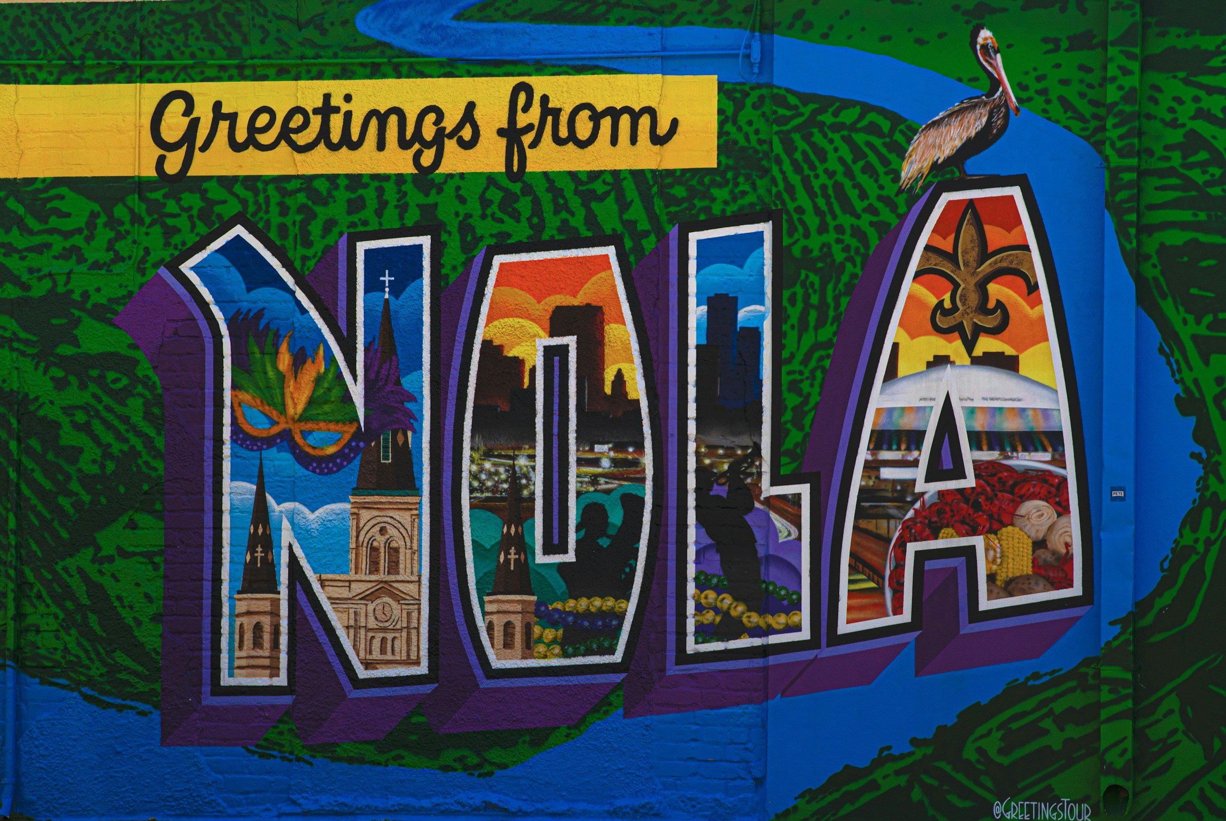 Colorful mural that says 'Greetings from MOA' with images of landmarks, sunsets, and local scenery.