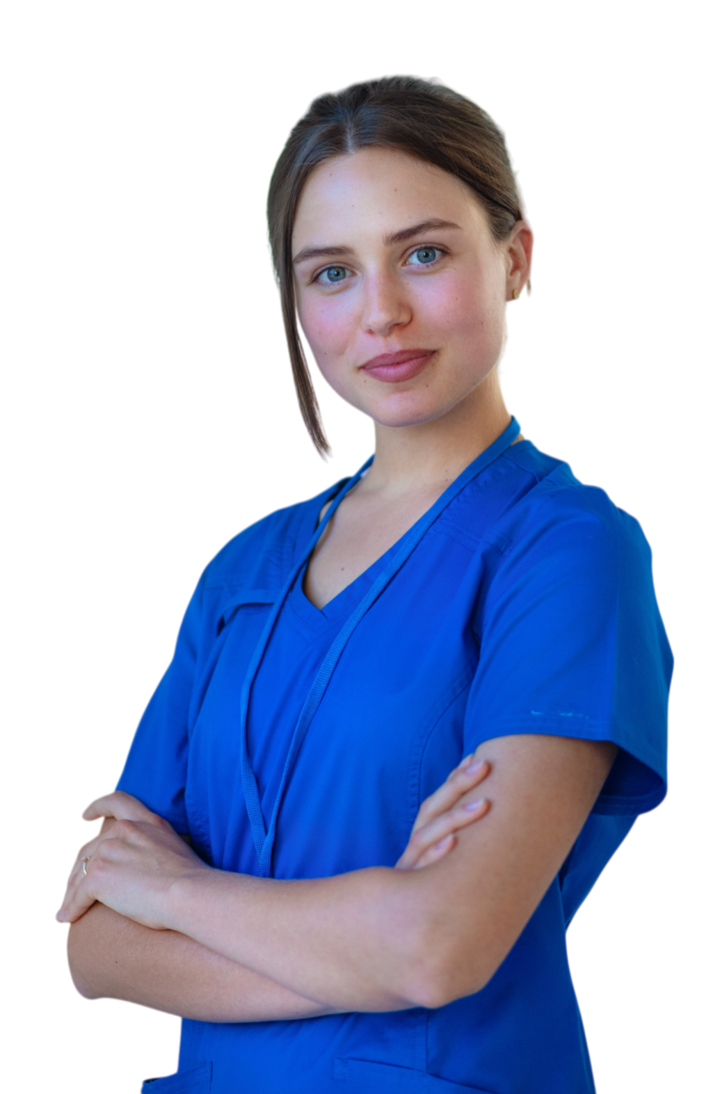 A young female nurse with light skin, blue eyes, and brown hair pulled back, wearing blue scrubs, standing with arms crossed and smiling confidently.
