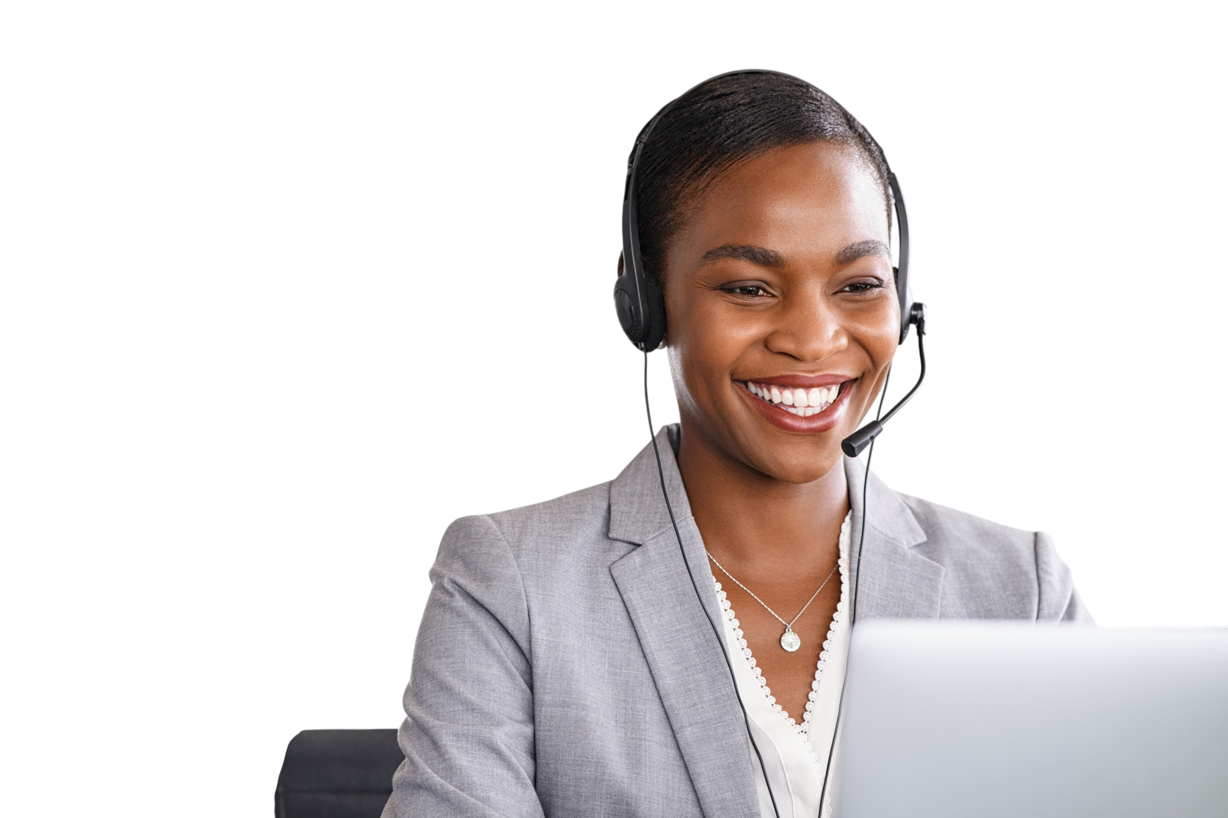 A smiling woman in a business suit with a headset, sitting in front of a laptop with a purple background.