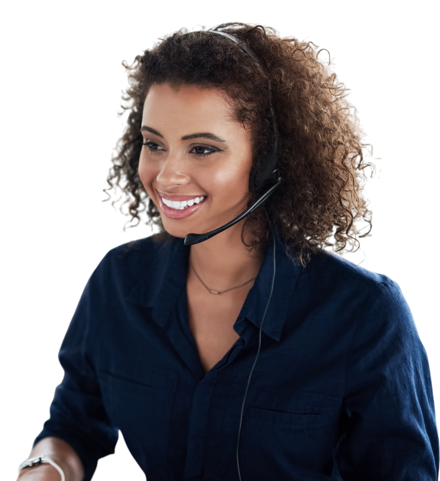 Smiling woman wearing a blue shirt and a headset with a microphone, working at her desk.