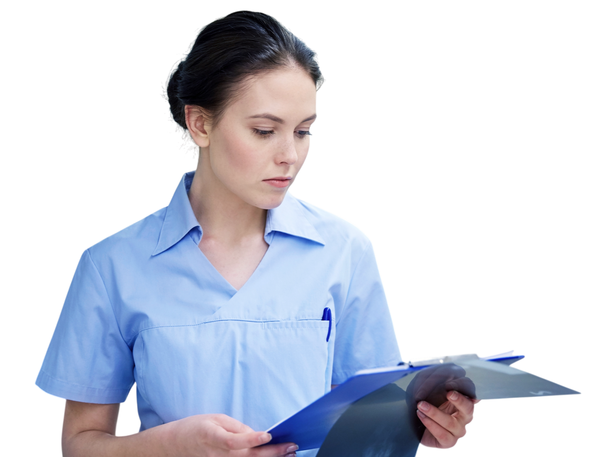 A nurse in blue scrubs looking down at a clipboard.