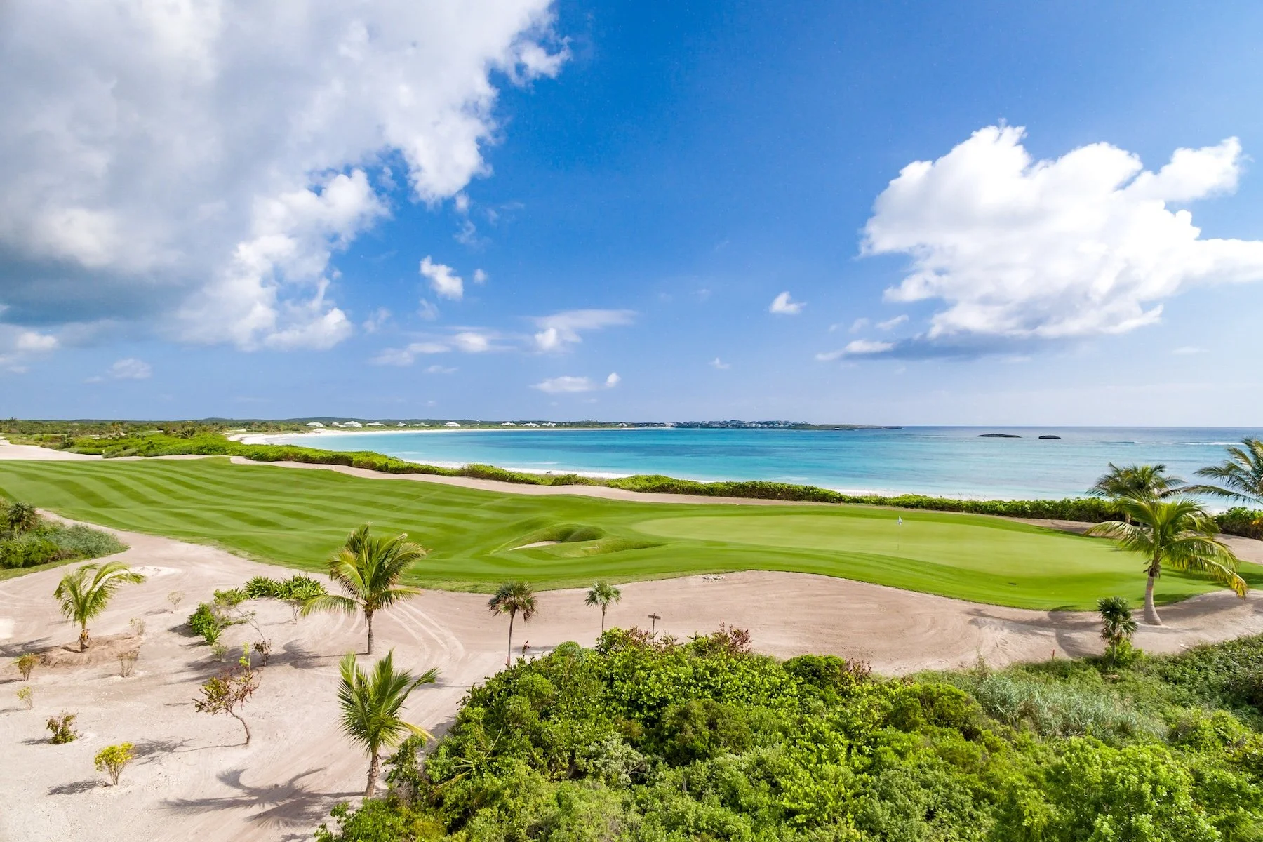 A hole on links-style The Abaco Club golf course stretching along Winding Bay on Great Abaco Island in the Bahamas