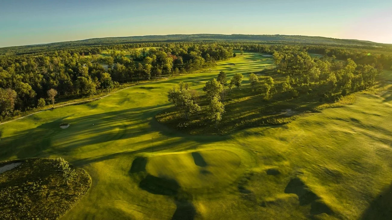 Sunshine and shadows bathe the tree-lined fairways of The Loop at Forest Dunes