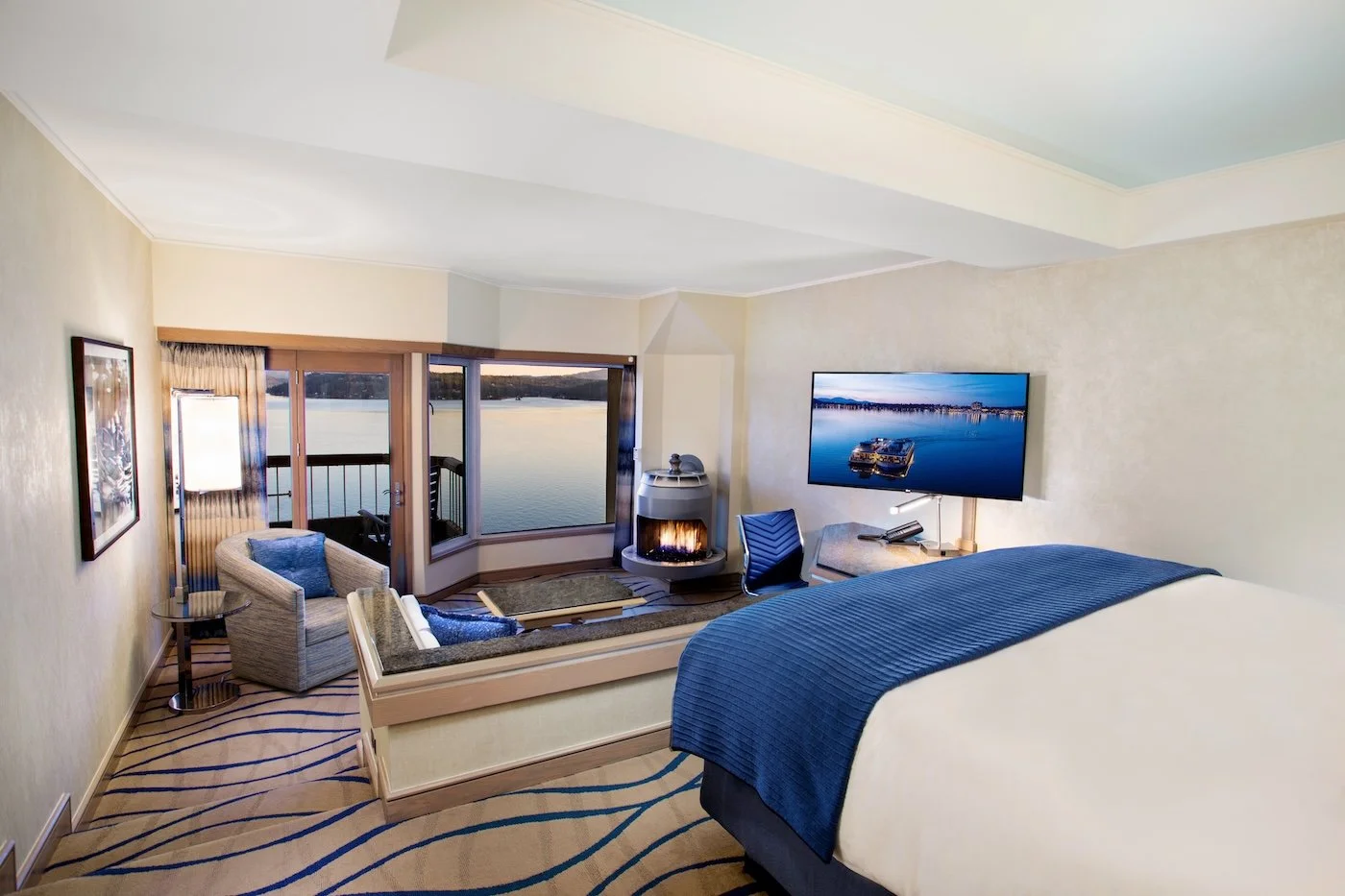 Lake Tower guestroom at the Coeur d’Alene Resort with a fireplace and balcony overlooking Lake Coeur d’Alene.