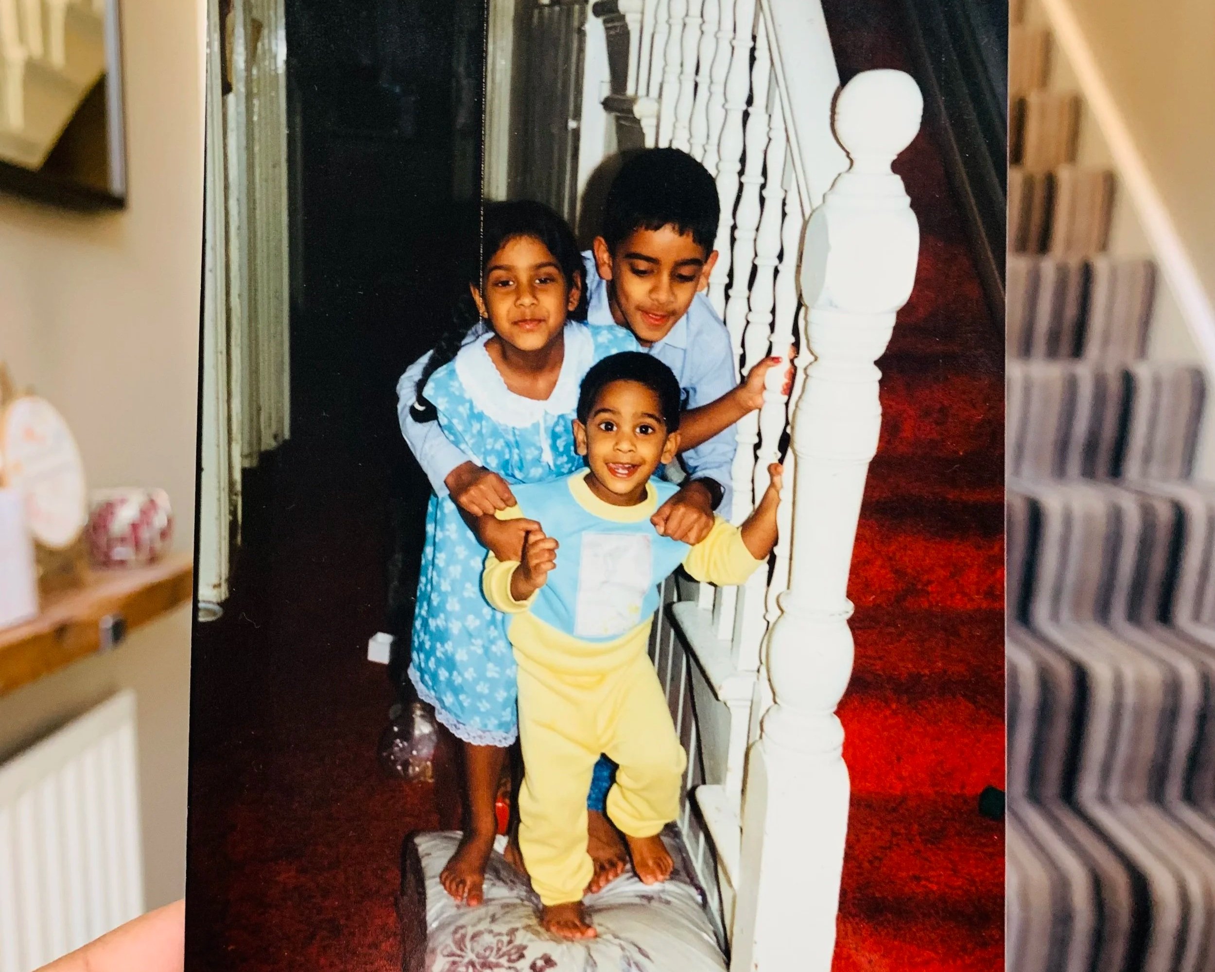 An overlay of a coloured image of three young children standing on a footstool next to a set of stairs. The image is overlayed the reality to line the stairs up with the real life version to show how the space is evolved