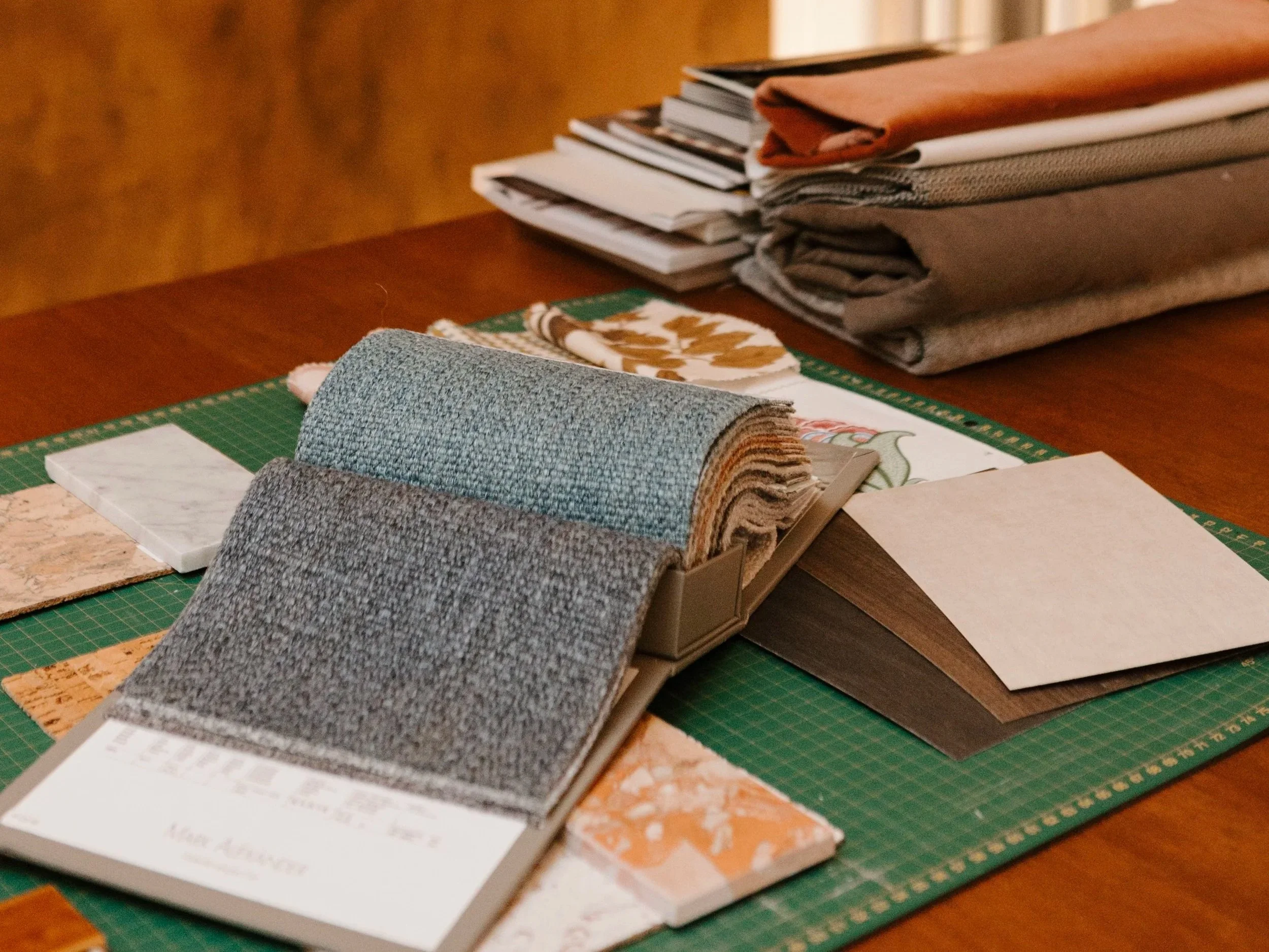 Samples of fabric swatches and color samples on a craft table.