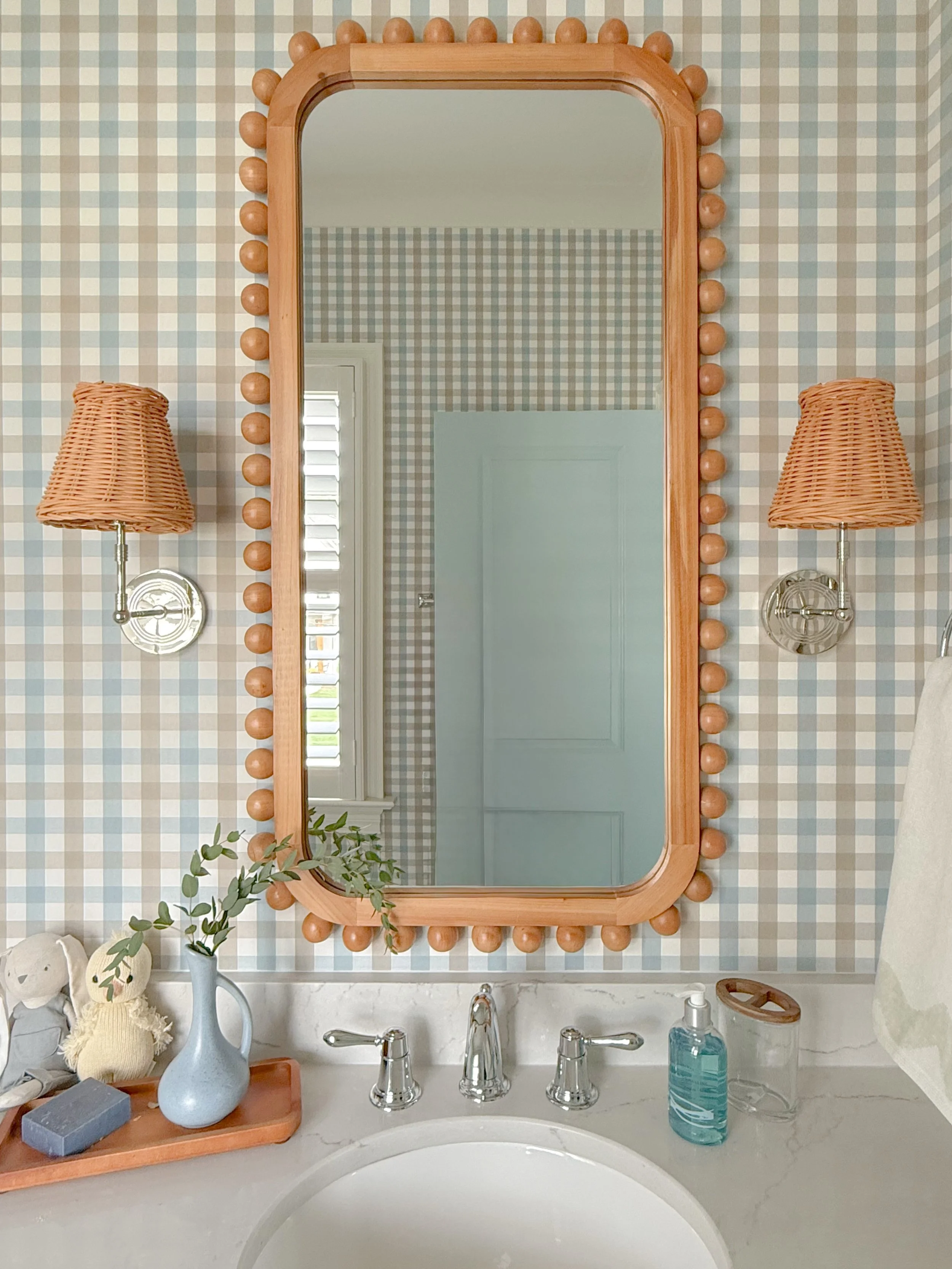 A little peek into baby boy #4&rsquo;s en-suite 🫶

Gingham wallpaper makes it feel timeless, but the rattan sconces and beaded mirror keep it feeling fresh.

He may be the youngest, but I&rsquo;m pretty sure he landed the best room in the house 😉