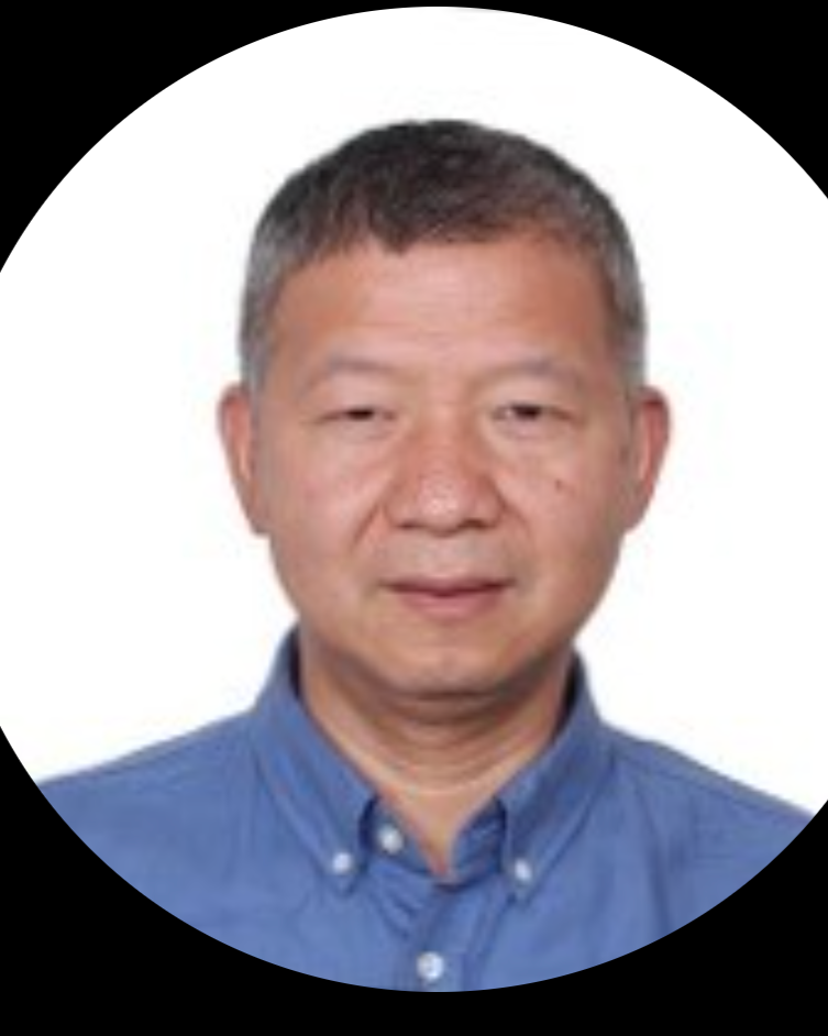 Close-up portrait of a middle-aged Asian man with short black and gray hair, wearing a blue collared shirt, against a white background.