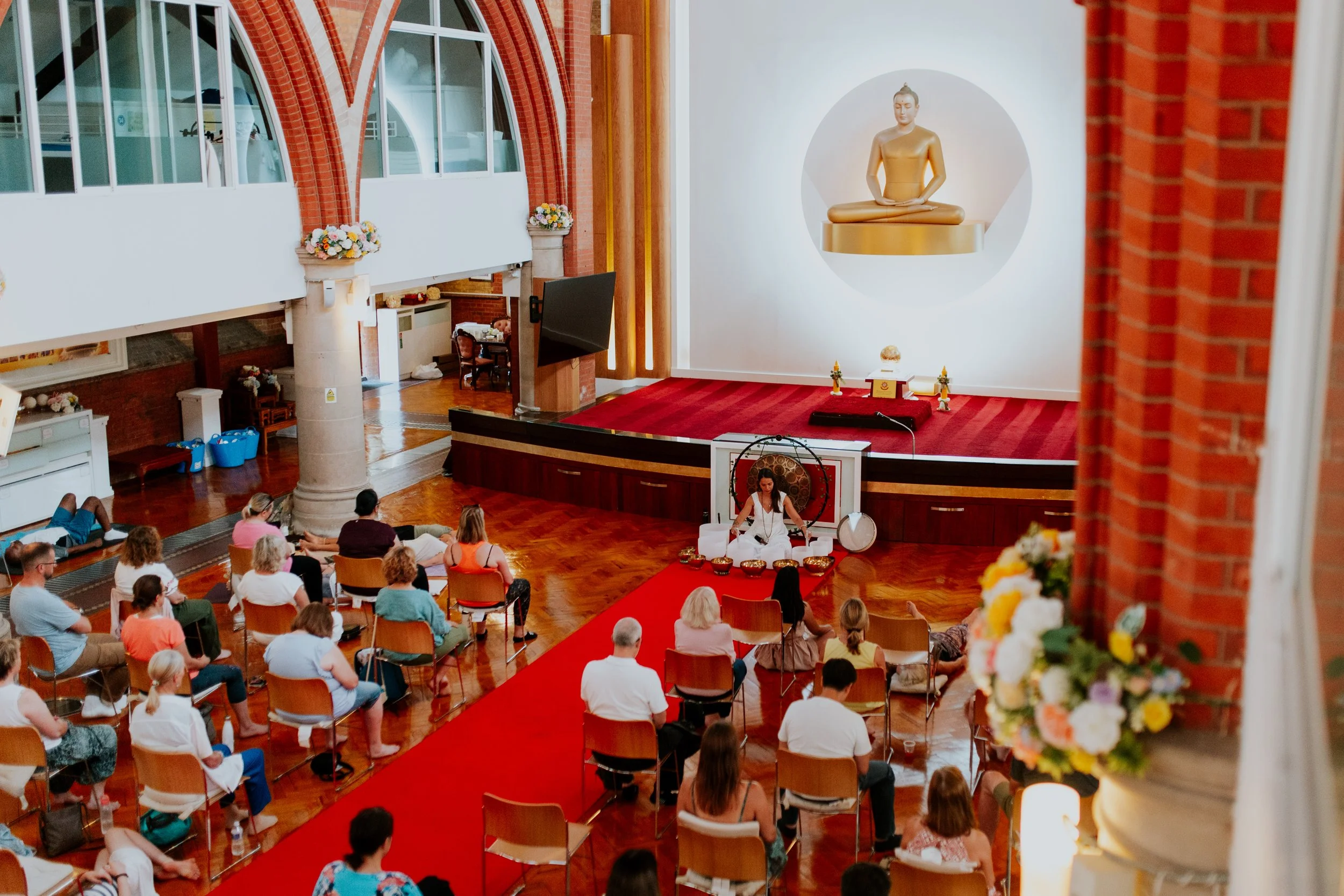 image of group gathered inside bisley yurt with budha image in background