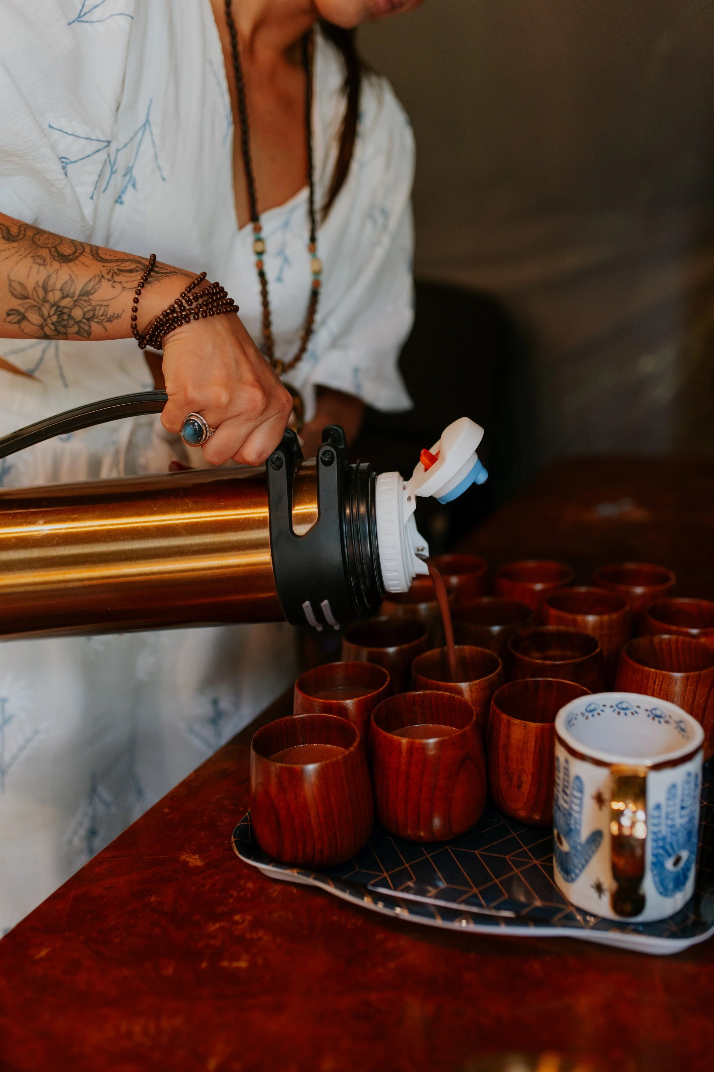 Suia pouring sacred cacao at ceremony