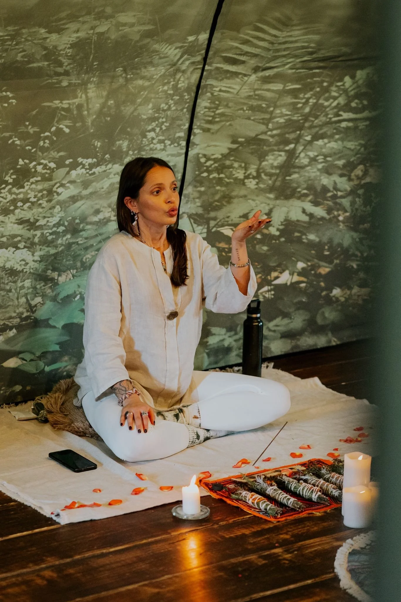 Suia knealing down conducting breathwork