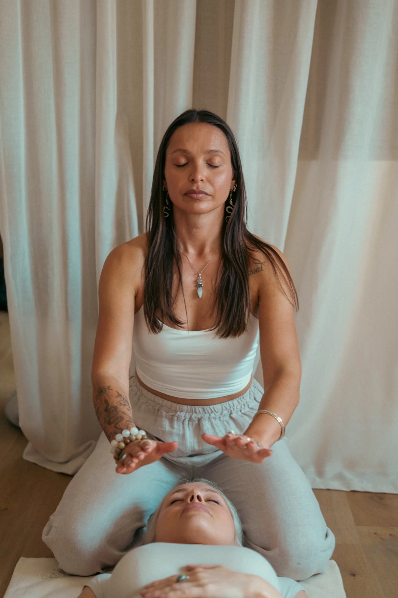 Suia with closed eyes working client lying down 