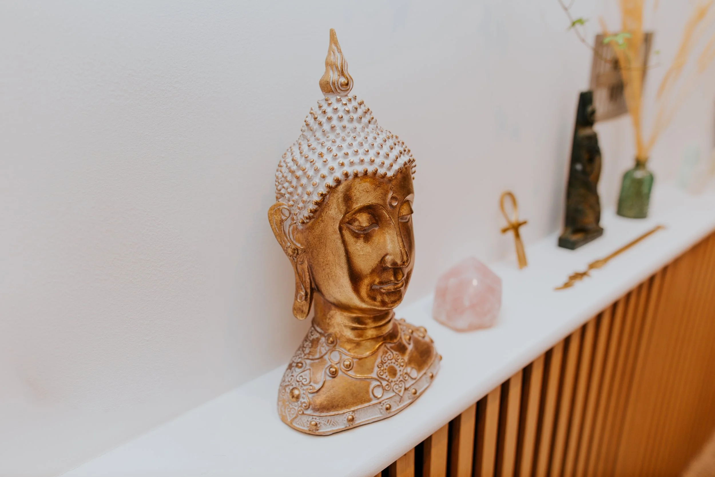 table with budha torso nd crystals arranged on top