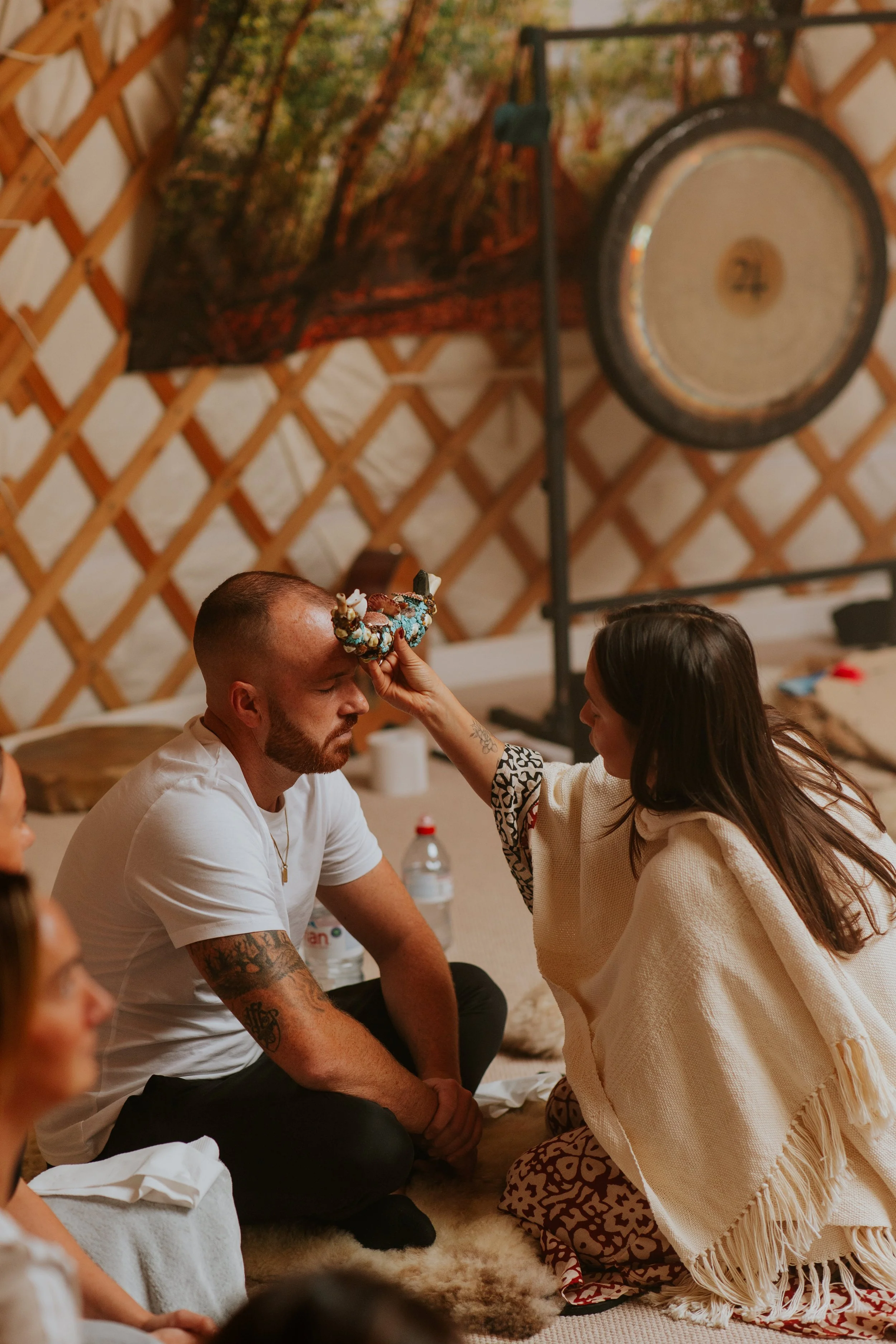 Suia touching client's head in healing ceremony