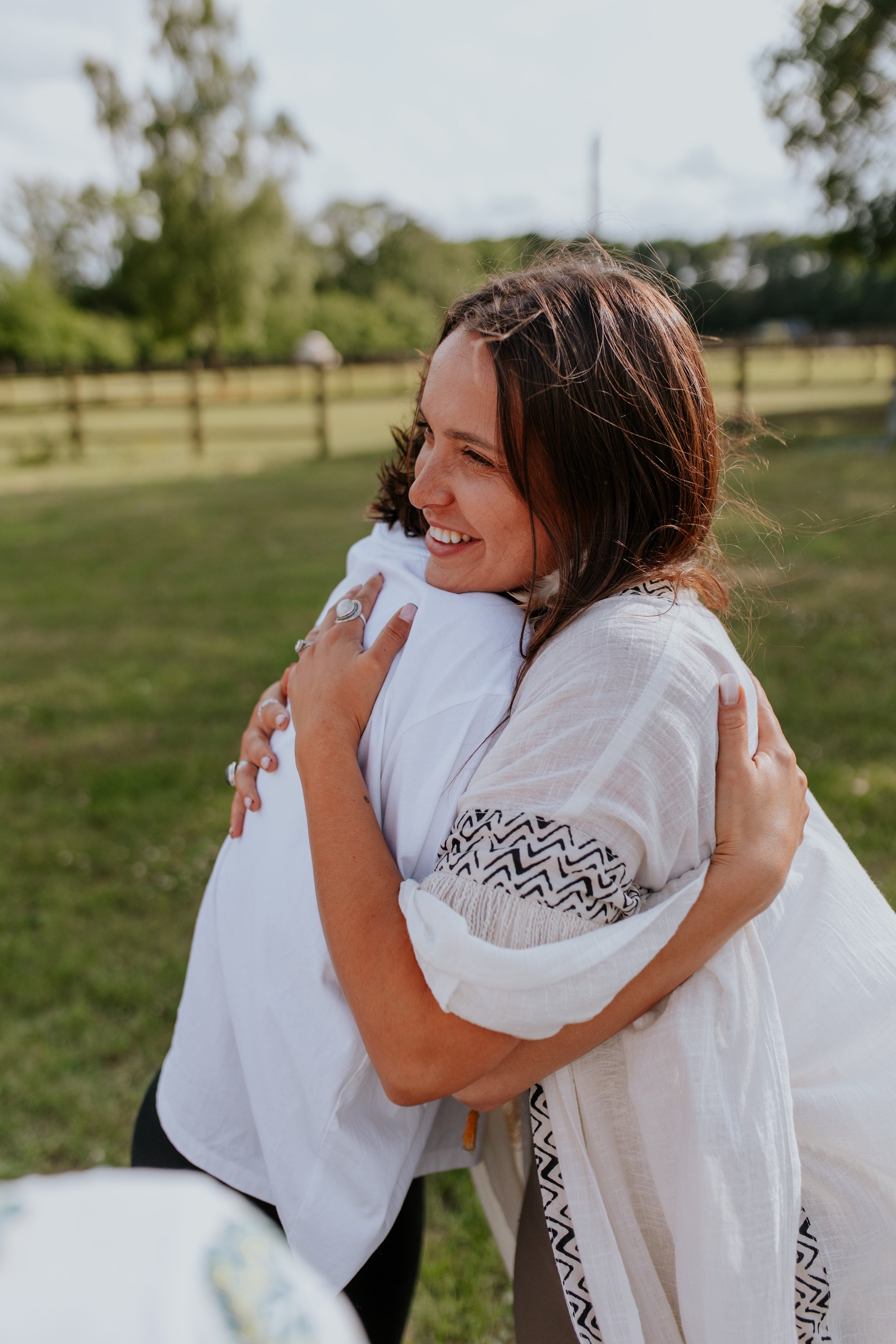 Suia smiling hugging a client