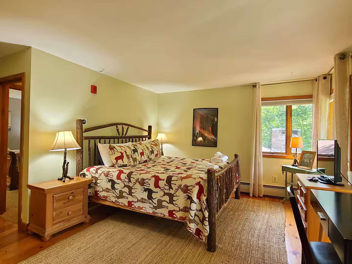 Bedroom 1 - King bed | Upper level | Jack-and-Jill bathroom

Your private retreat with mountain views, access to a secluded deck through sliding doors, and a flat-screen TV. The walk-in shower bathroom connects to Bedroom 2.