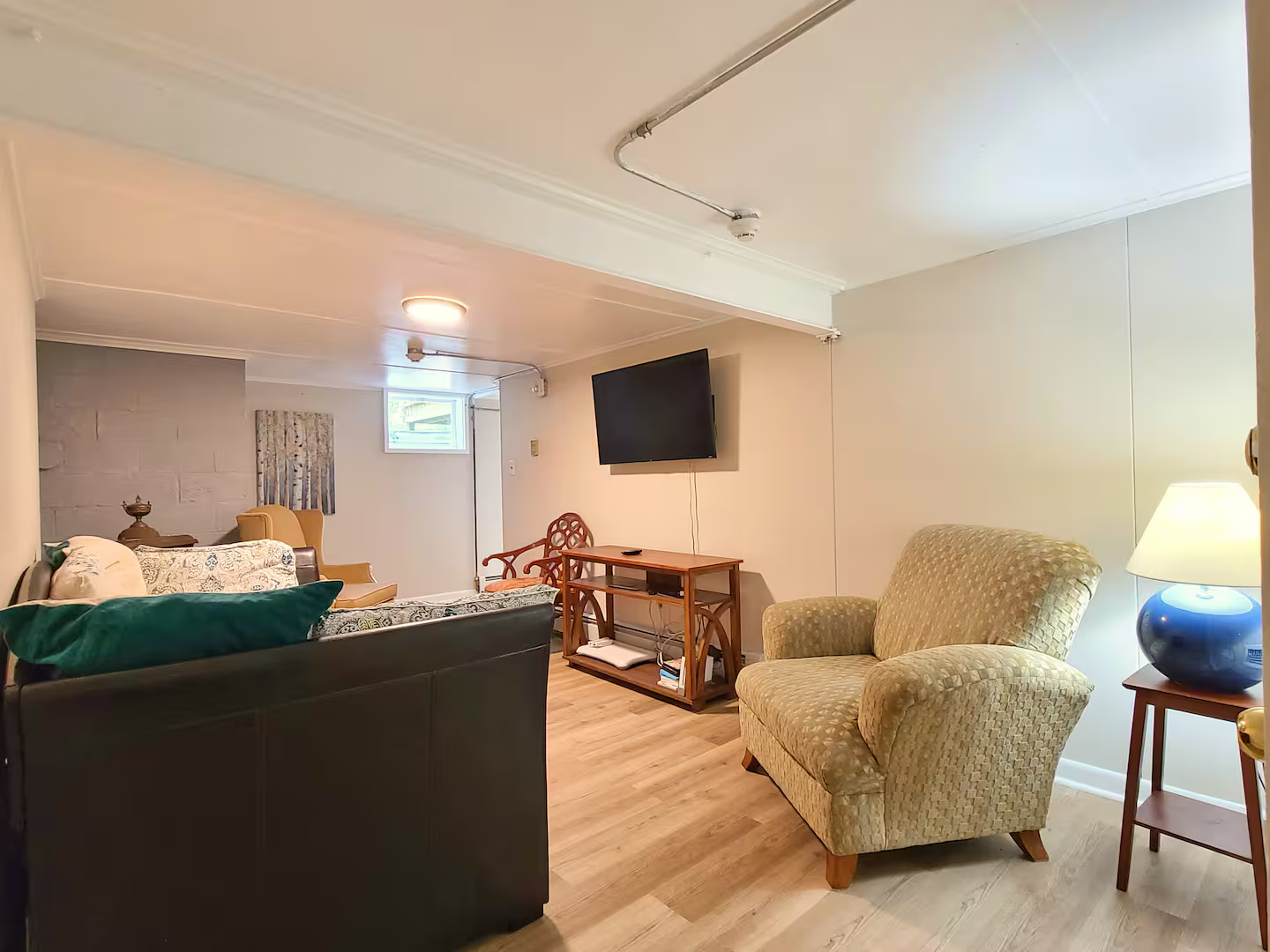 Additional sitting/tv area in the basement that's great for kids. With [video games]