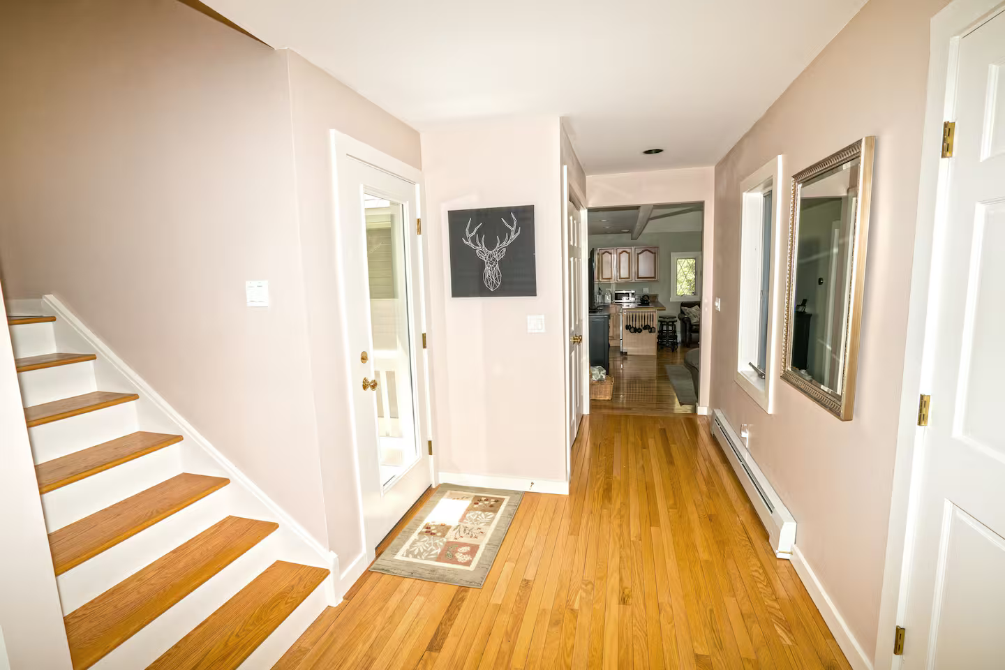 Staircase leading to the upper level bedroom, bathroom and loft area.

Door providing access to the backyard, including a picnic table, gas grill, and fire pit area.