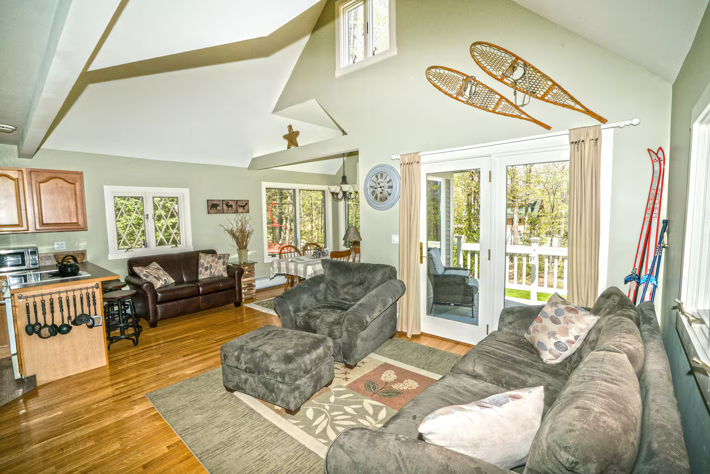 Main Living Area
Open-concept living space with comfortable seating, flat-screen TV, and direct access to the front deck—perfect for relaxing after a day on the slopes.