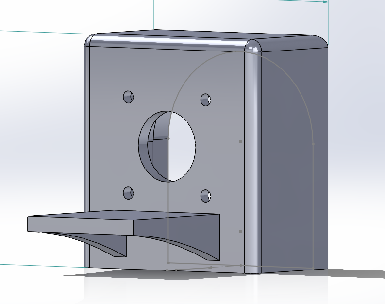 A 3D-rendered metal mechanical part with a central circular cutout, four smaller holes around it, and a protruding horizontal extension at the bottom.